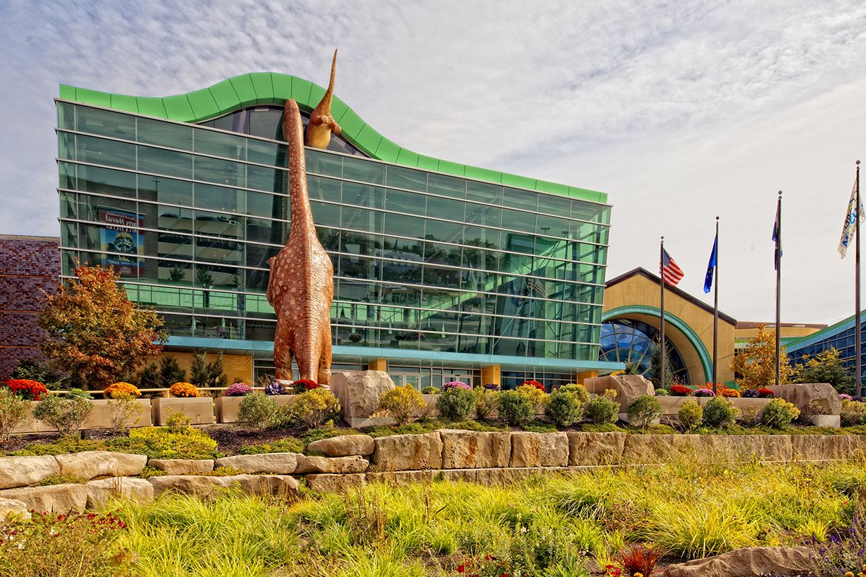 Entrance view of The Children’s Museum of Indianapolis and its dinosaur display.