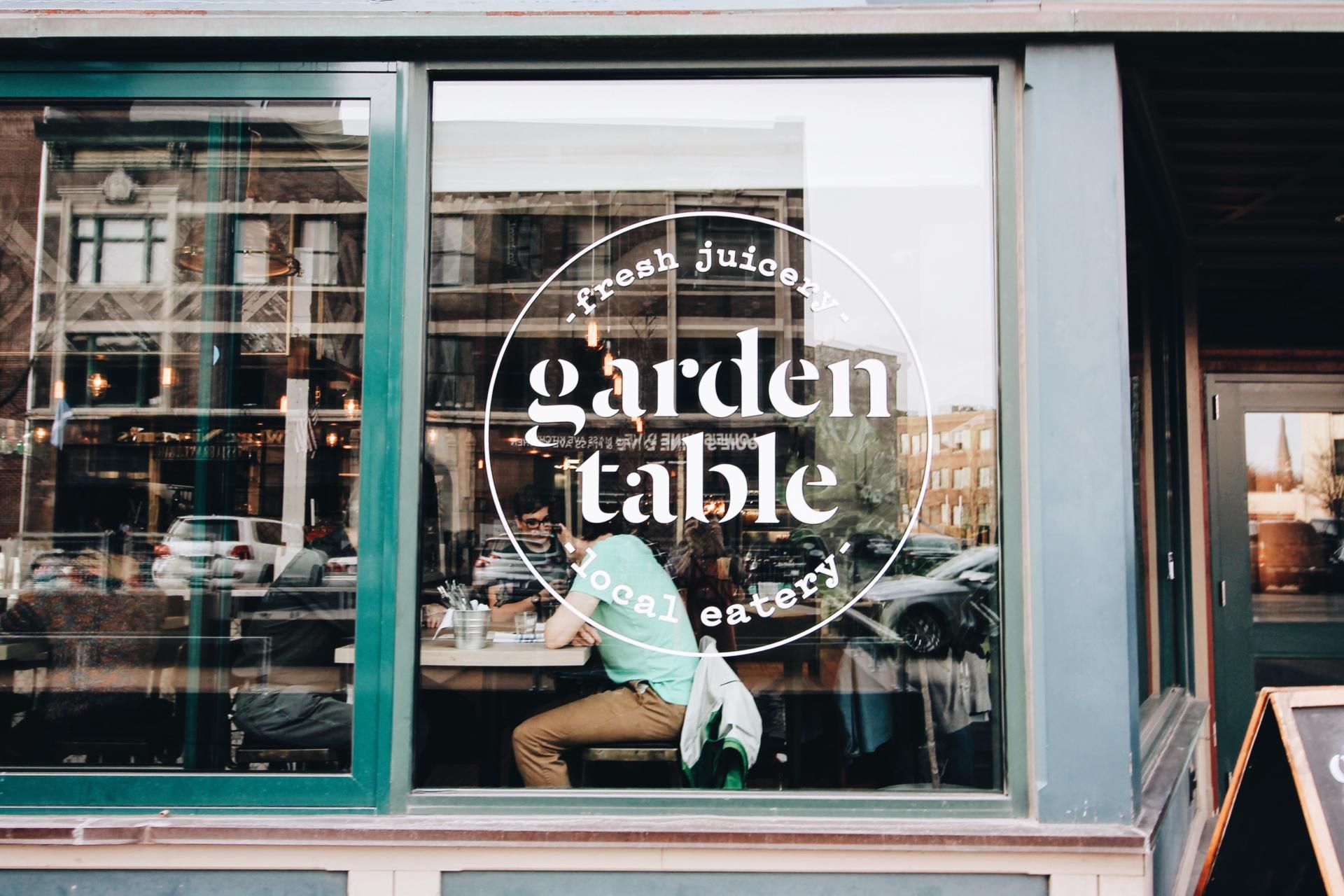 View of guests dining inside Garden Table from the street. 