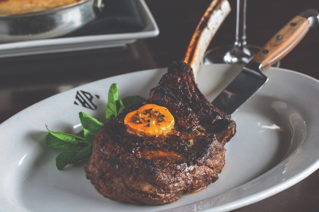 Bone-in steak topped with butter.