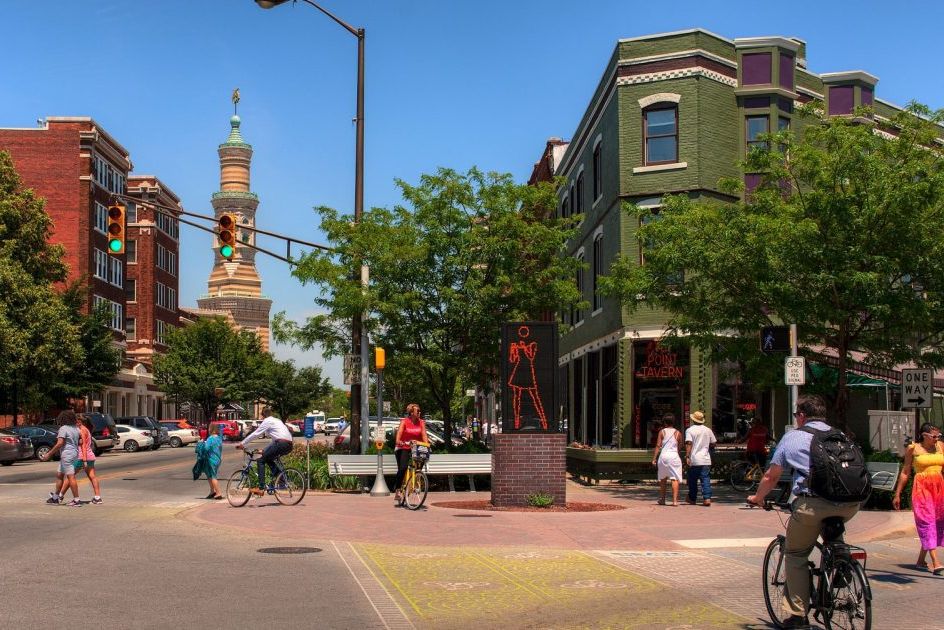 Visitors stroll and cycle along Mass Ave in downtown Indianapolis.