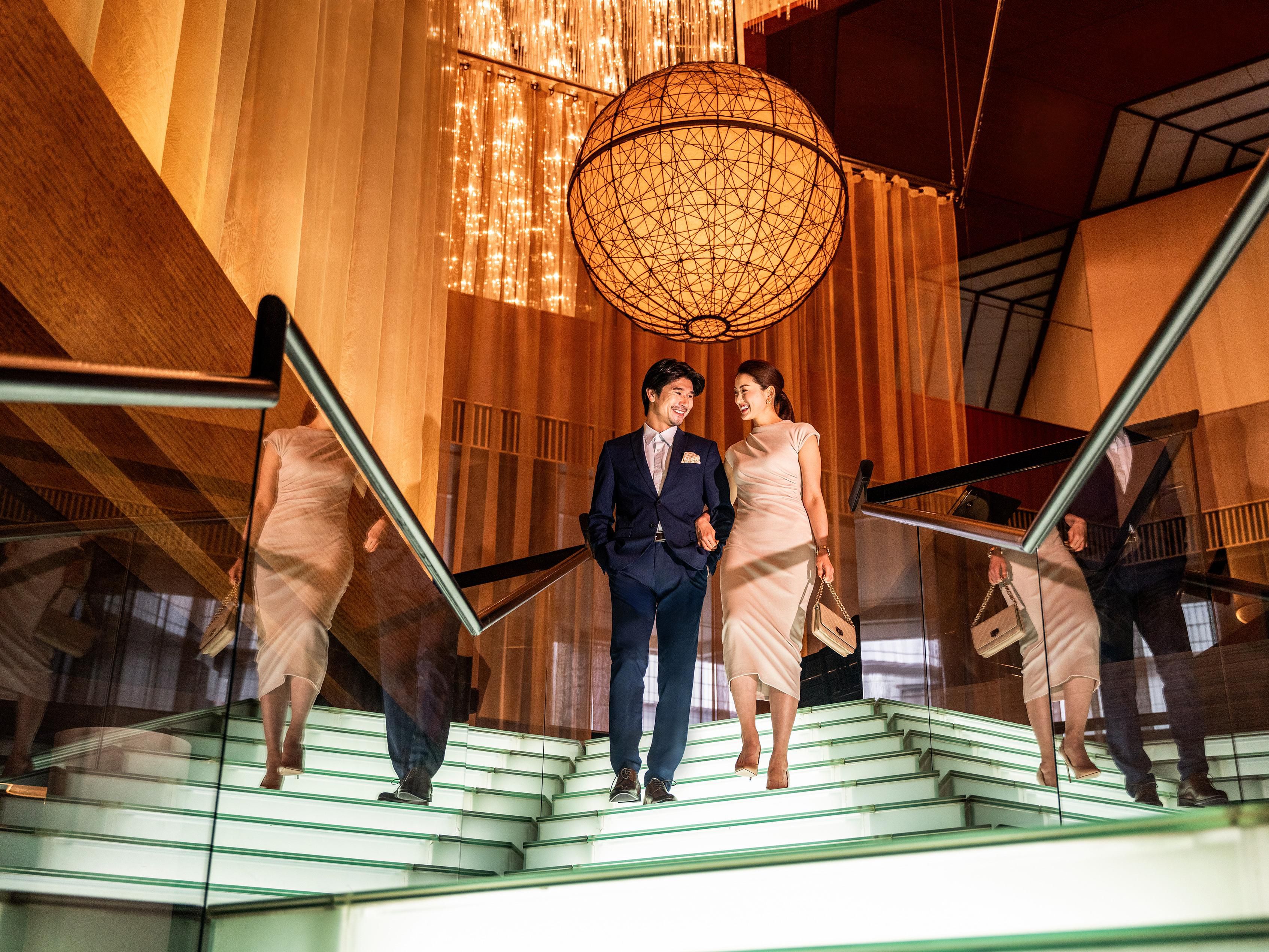 An atrium lobby featuring an illuminated staircase.