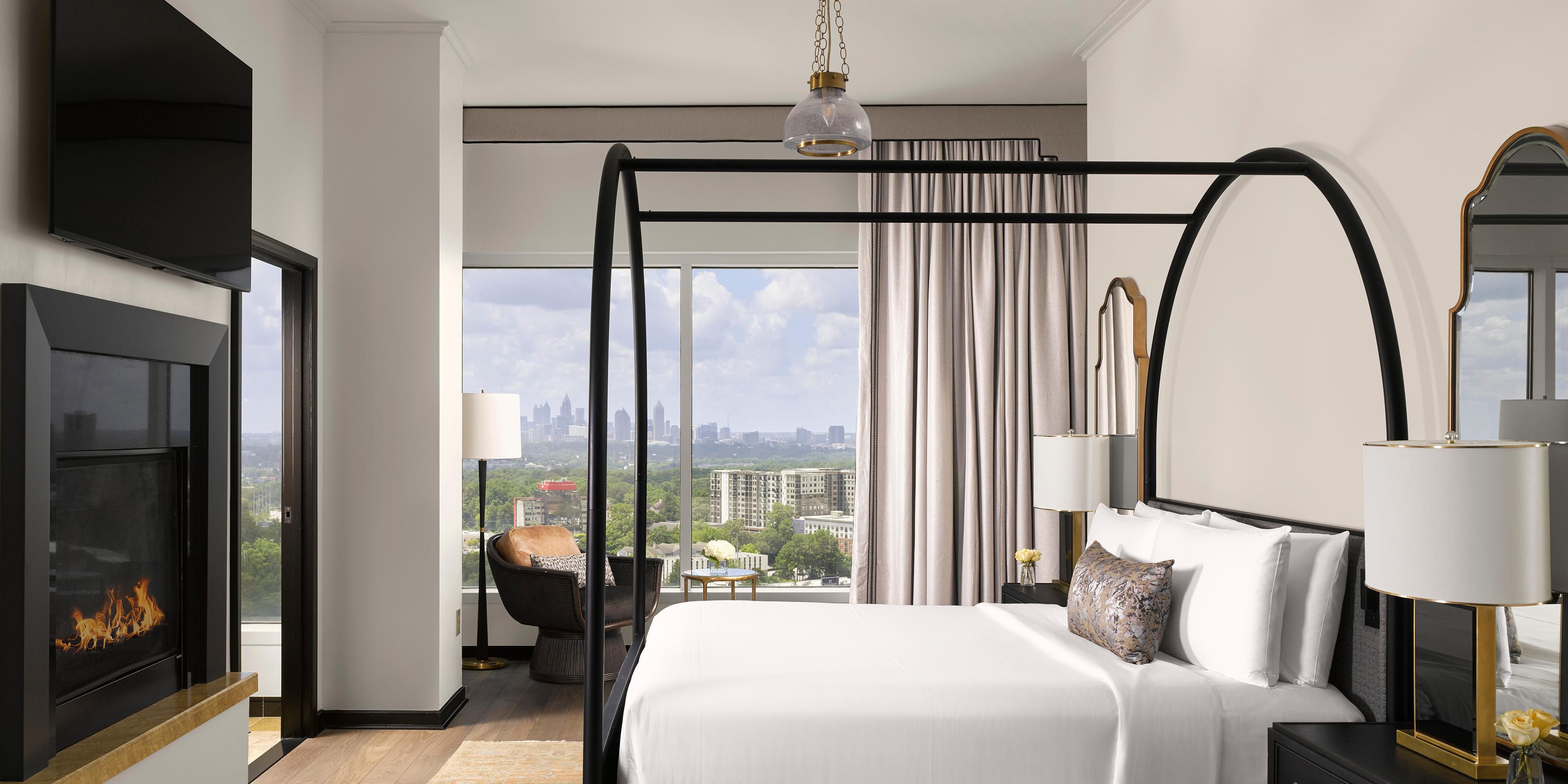Presidential Suite Bedroom with Fireplace and City Views.