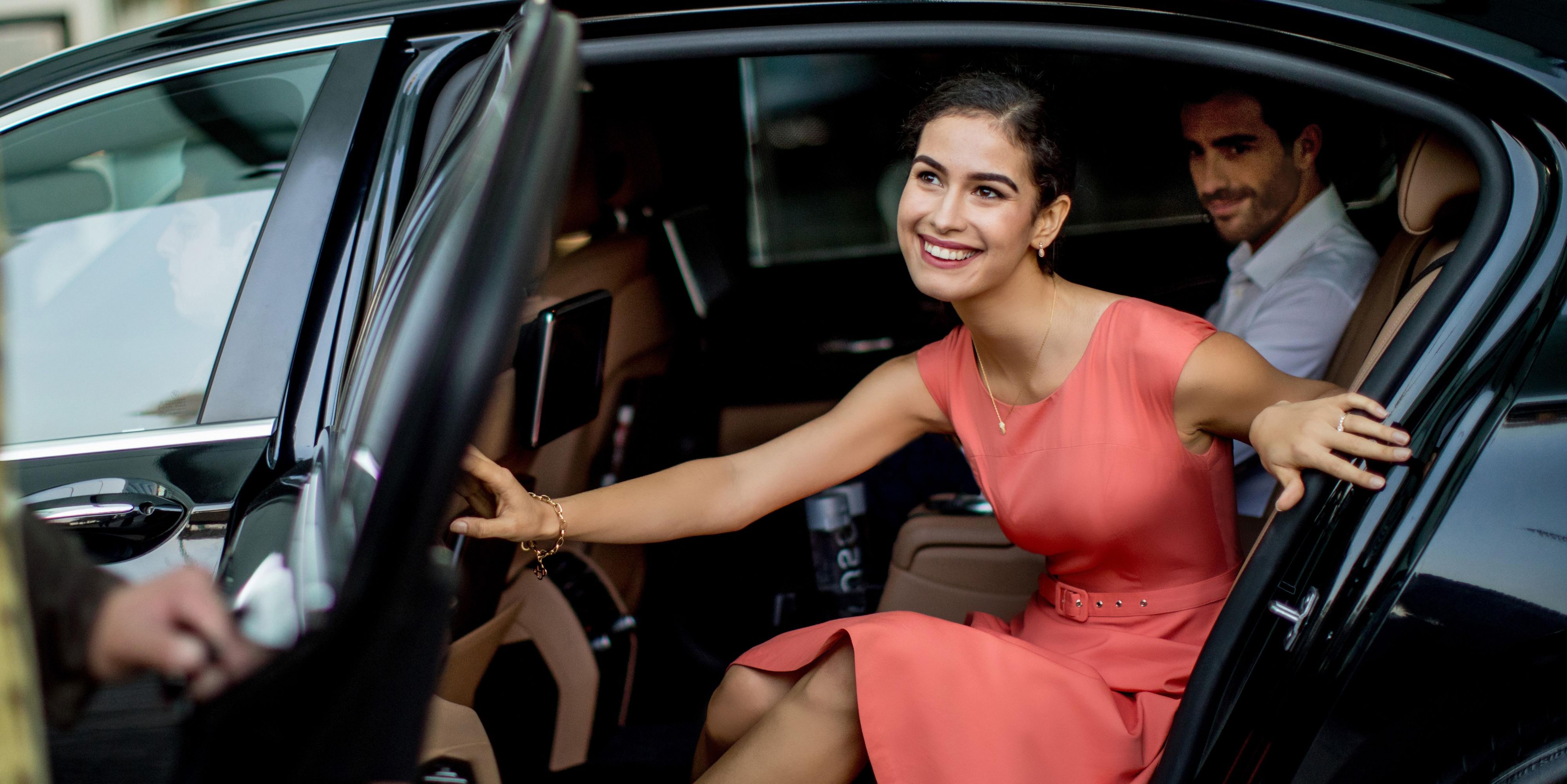 Woman getting out of car at valet.