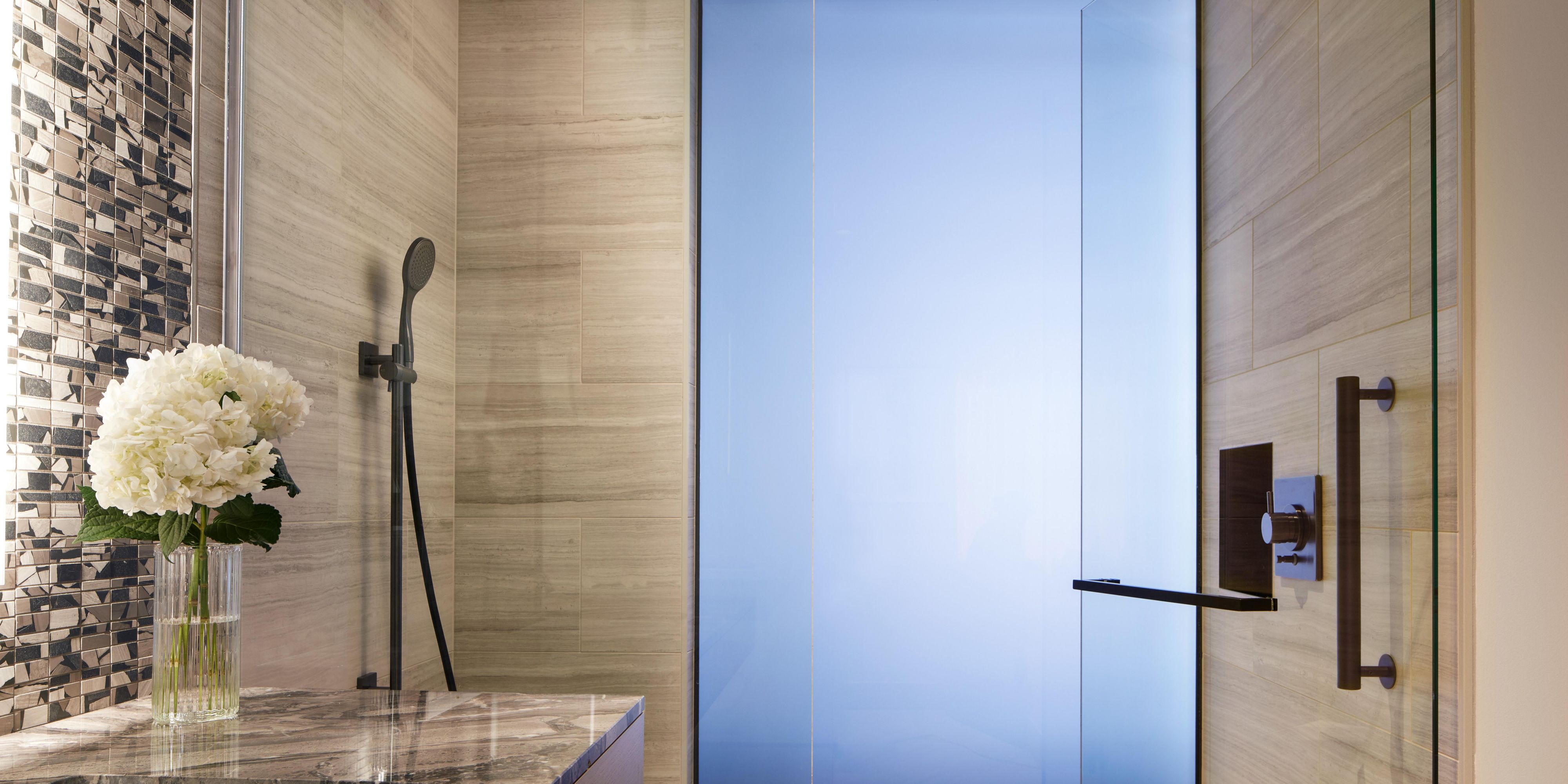 Smoked glass wall design brings in light while maintaining privacy