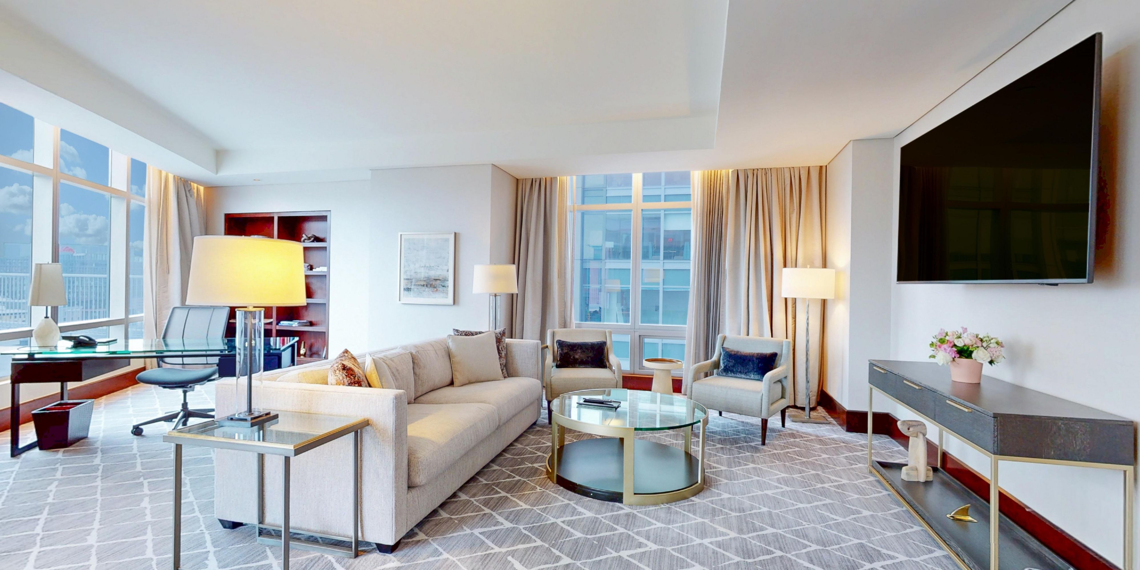 Spacious suite living room with panoramic waterfront views