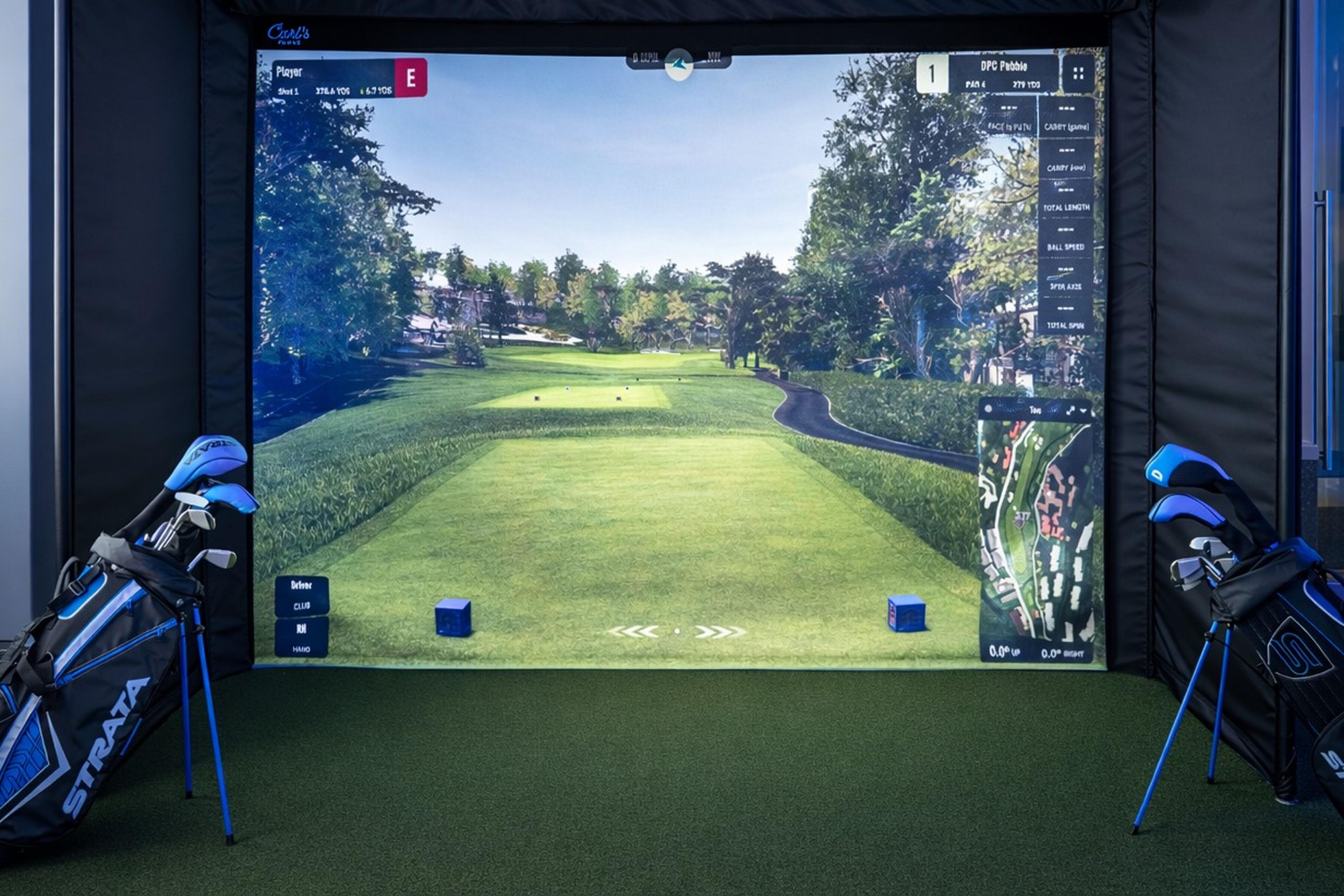 Indoor golf simulator with course view and golf bags.