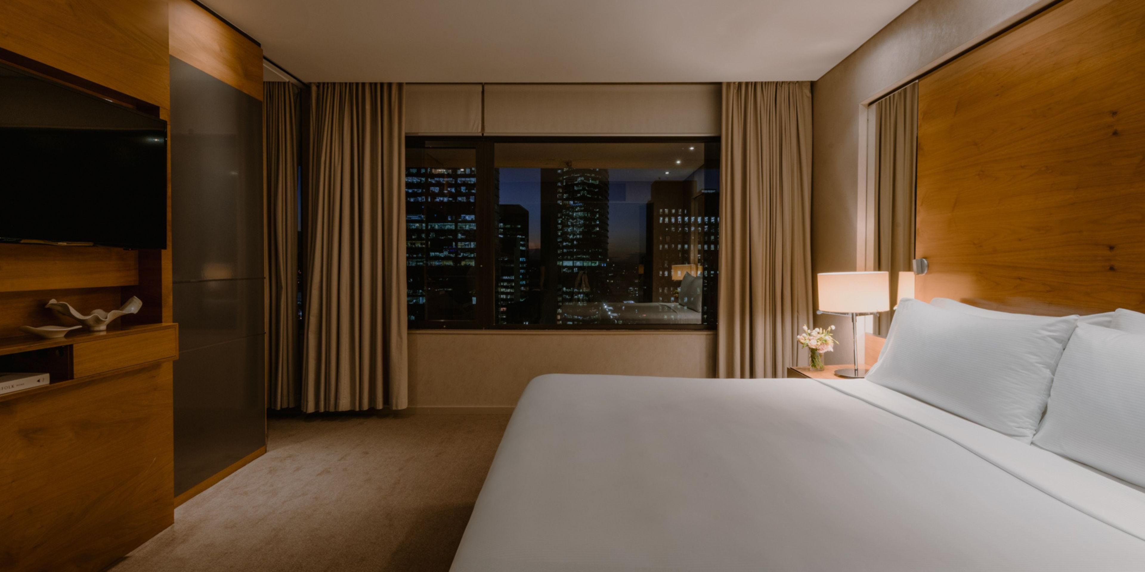 Suite Bedroom with city skyline evening views