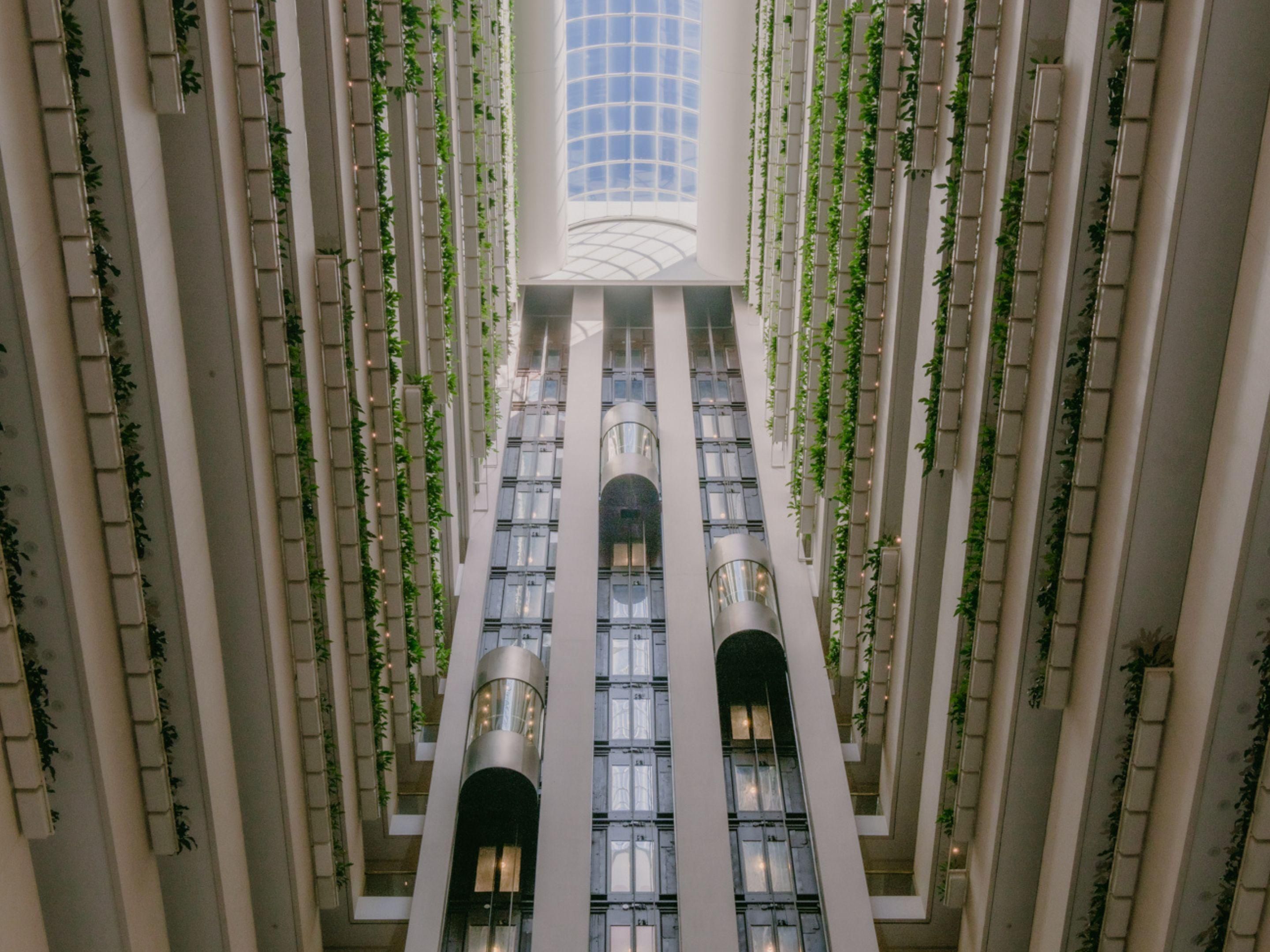 The view of the atrium and lift capsules from the hotel lobby