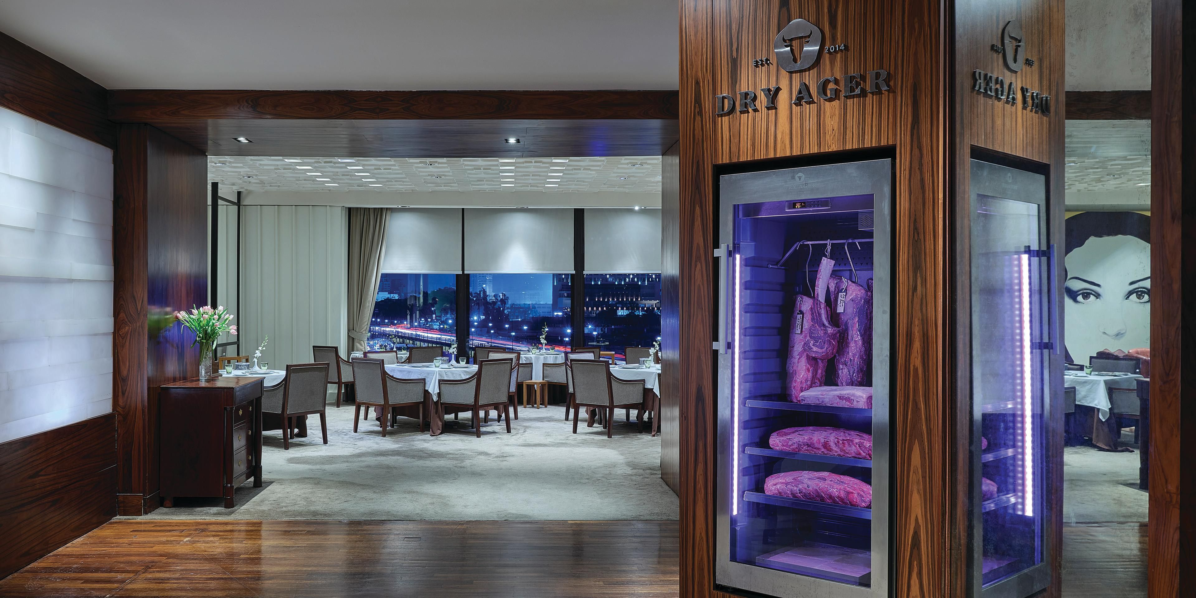 Be prepared for an exclusive experience and indulge in Dry-Aged American steaks at The Grill restaurant. The culinary team expertly aged the meat for 28 days before trimming it to the renowned ribeye cut, served at your preference.