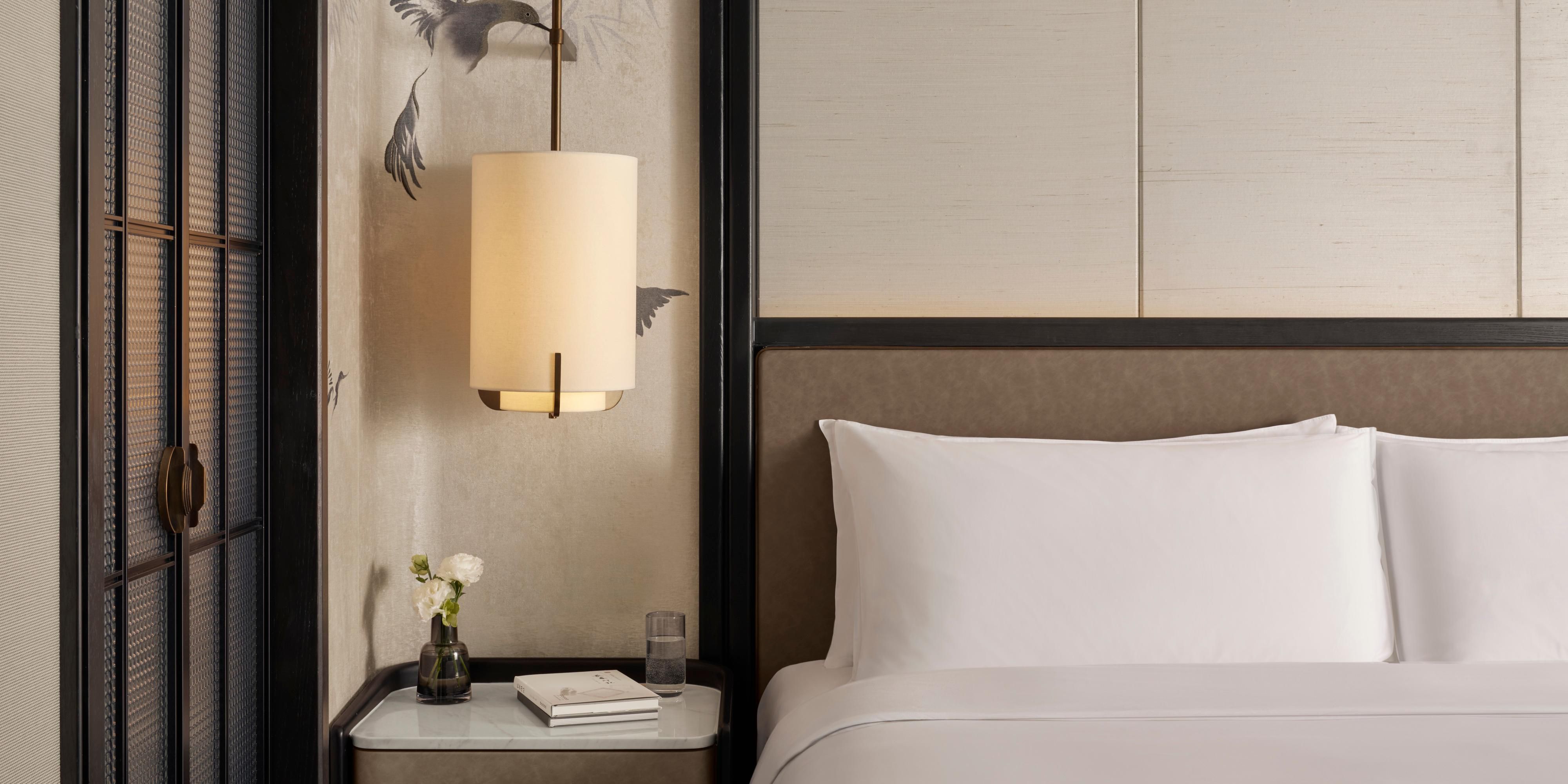 250 guestrooms blend wood/stone textures with floor-to-ceiling city views. Tranquil greenery & dappled light create poetic calm. Smart tech meets silk robes + Capsule Coffee. Enjoy butler service or gender-themed sanctuaries—urban oases soothing the soul amid bustling energy. Elevate your stay.