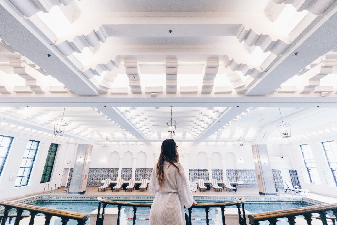 Woman overlooking large indoor pool