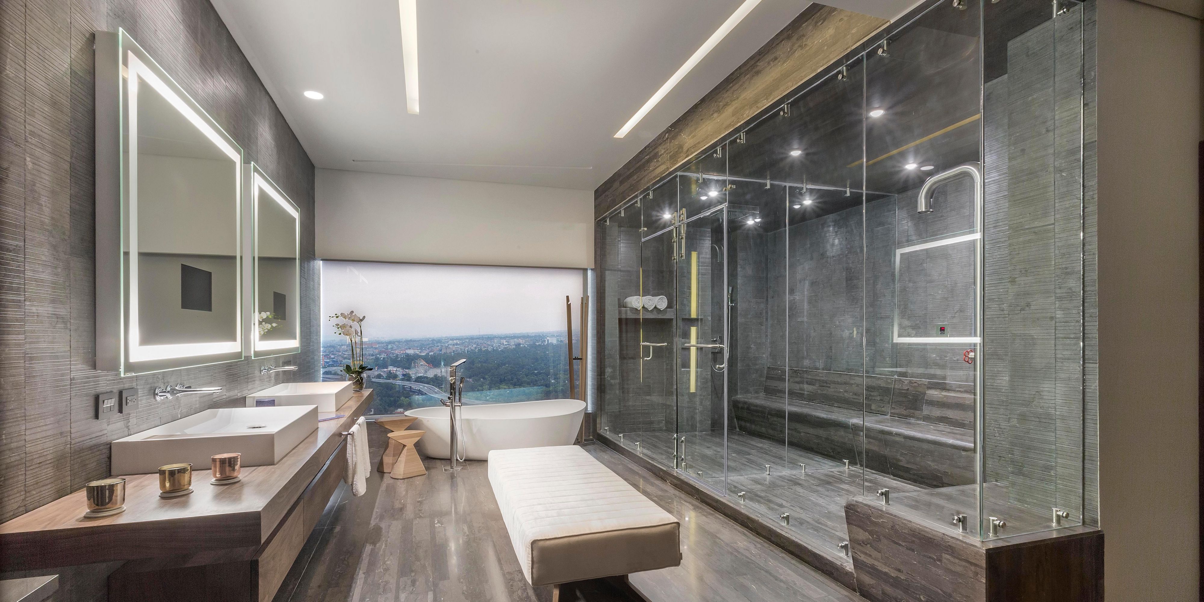 Spacious presidential bathroom with separate bath and shower.
