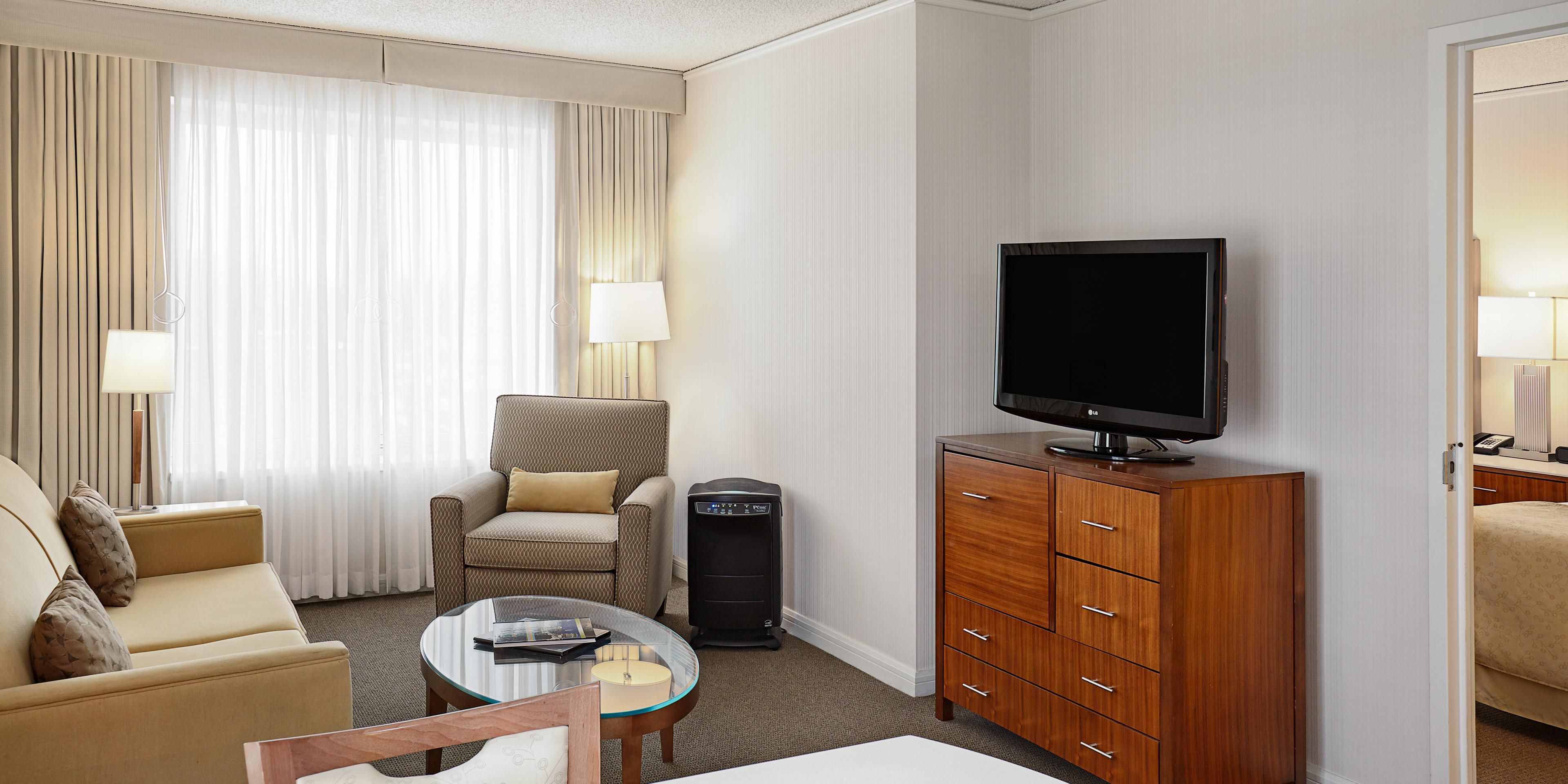 Spacious guest room with sleeper sofa, chair and dining table