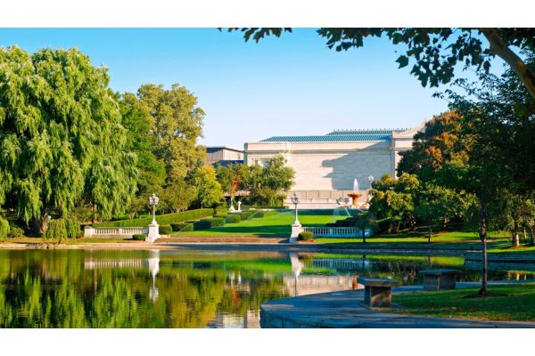 Hotel building overlooking a landscaped pond and fountains