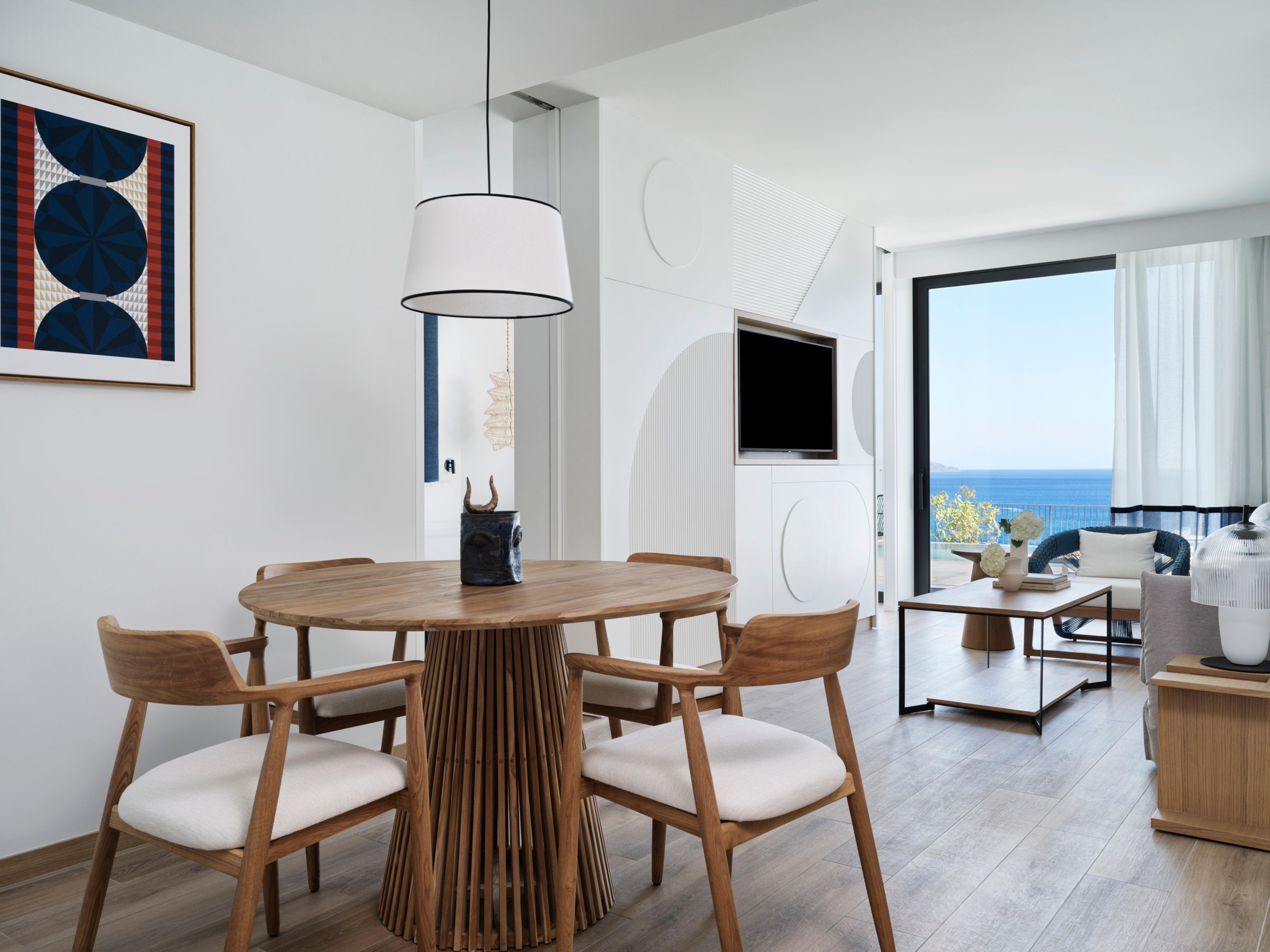 large suite living area with dining table and chairs and ocean views