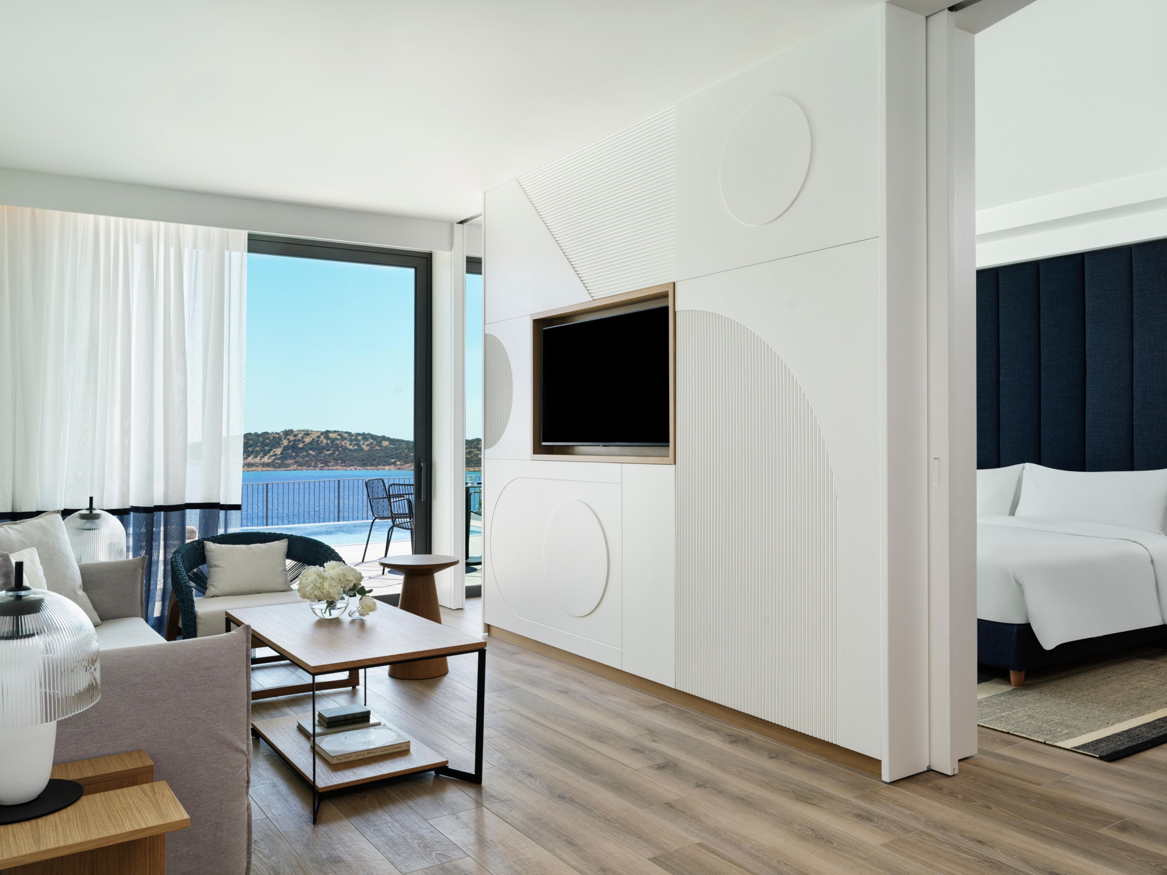 large suite living area with dining table and chairs and ocean views