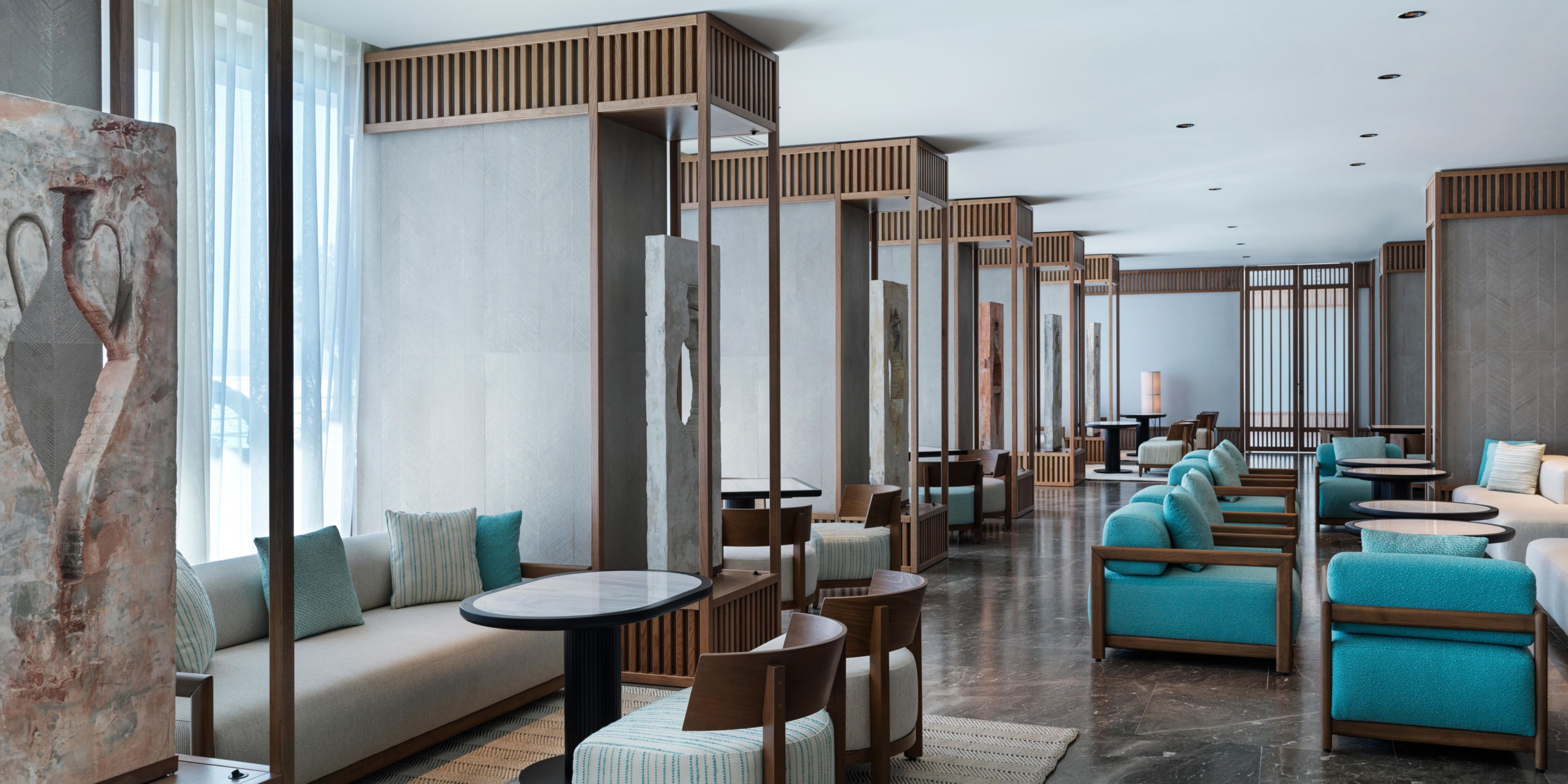 large lounge and bar area with booths and cosy armchairs
