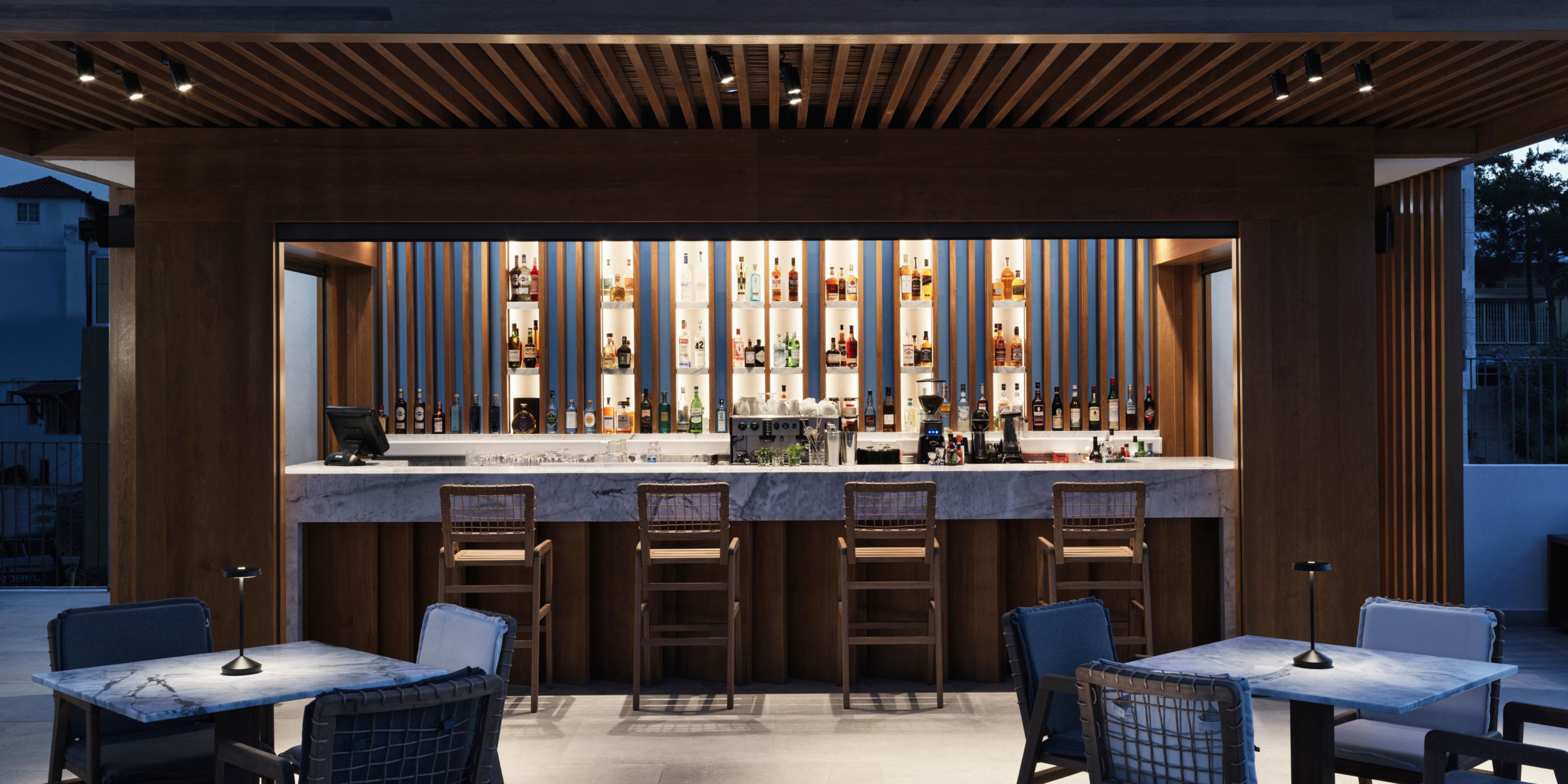 front view of Minoan bar, showing bar stools, and plenty drink and spirit options