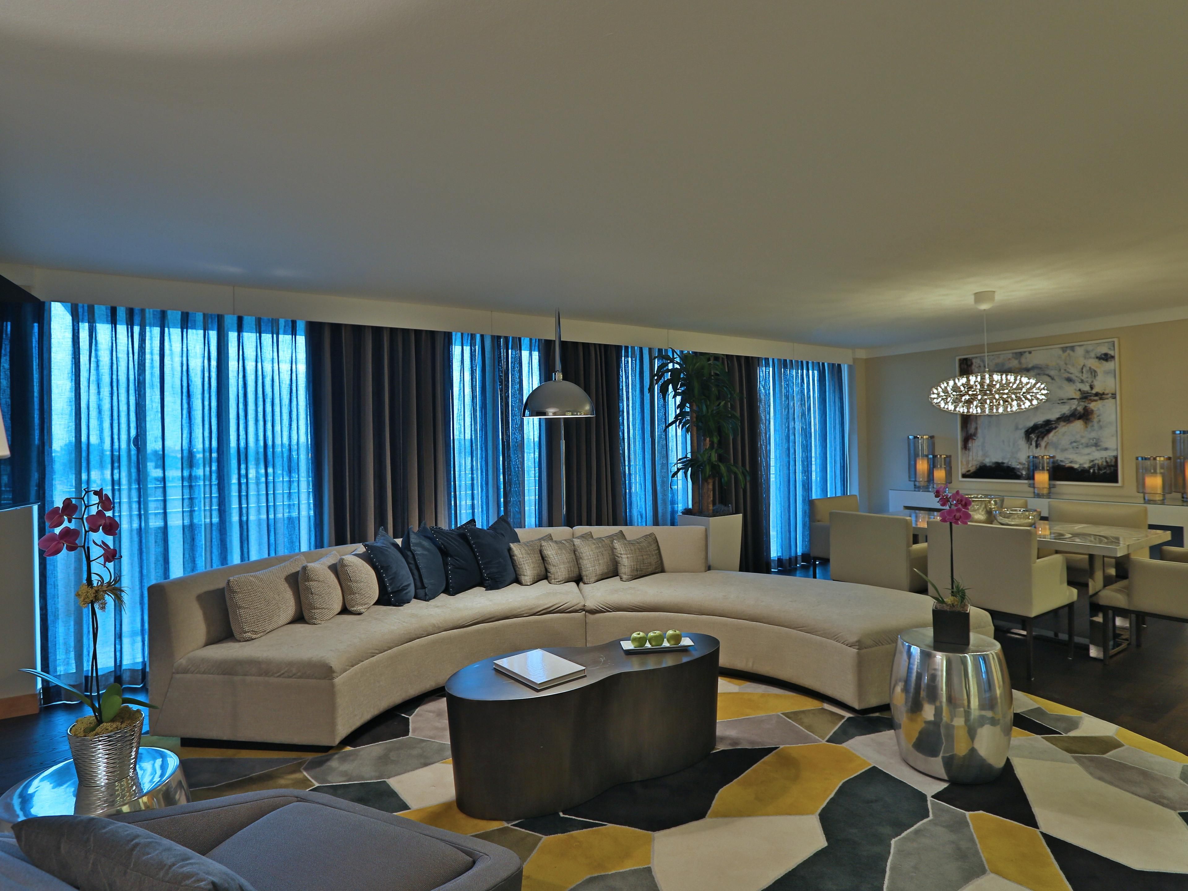 Luxurious presidential suite with elegant furnishings, and spacious living area.
