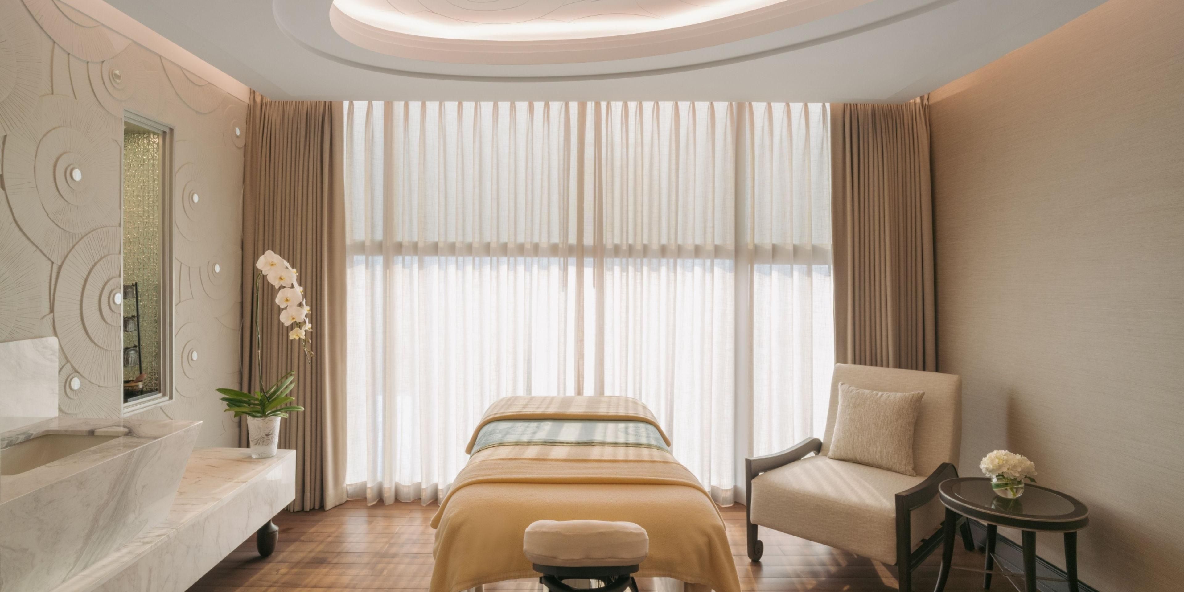 Spa room with massage tables and marble features.