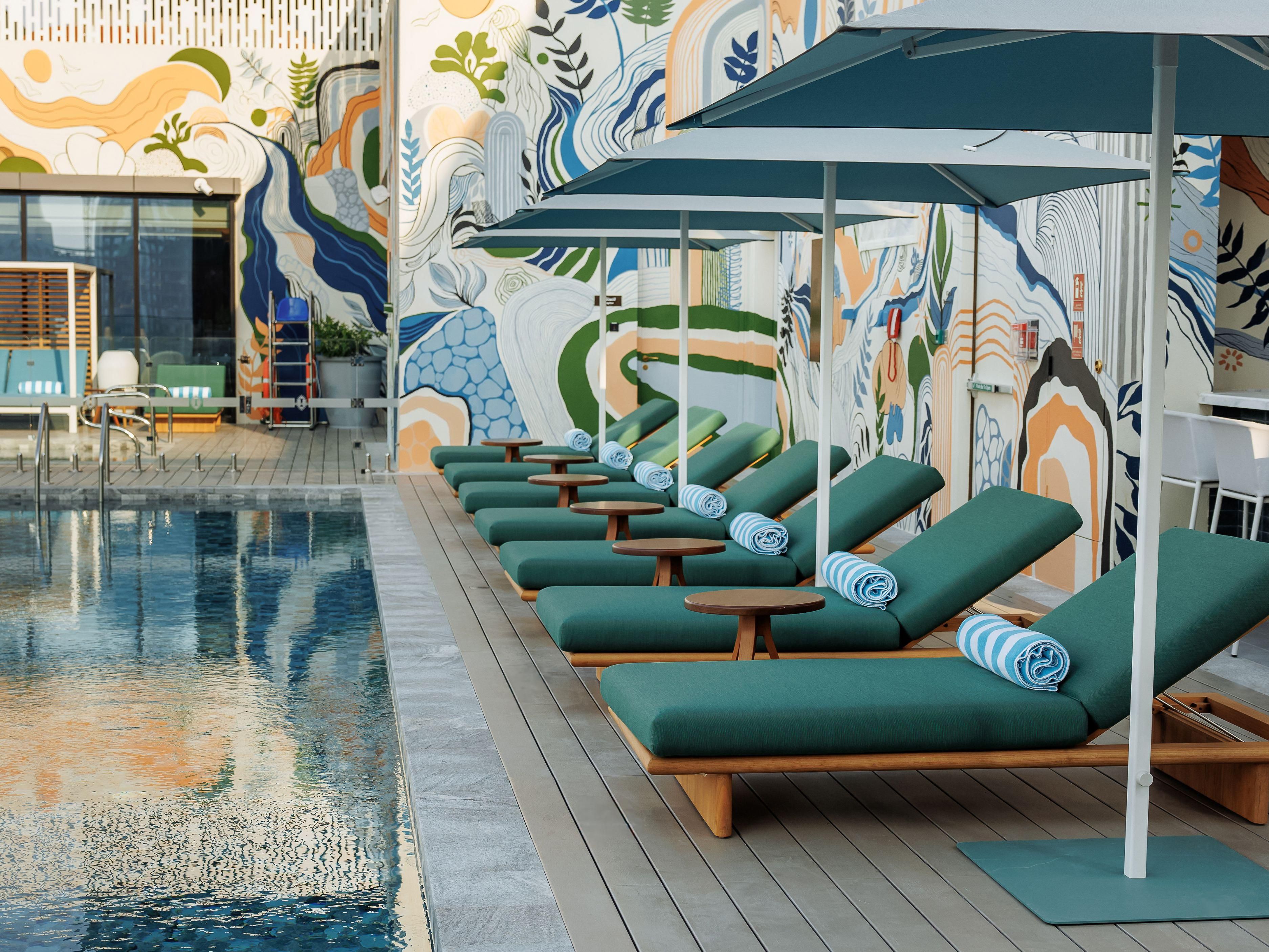 Relax on a cabana or a sunbed at our rooftop pool