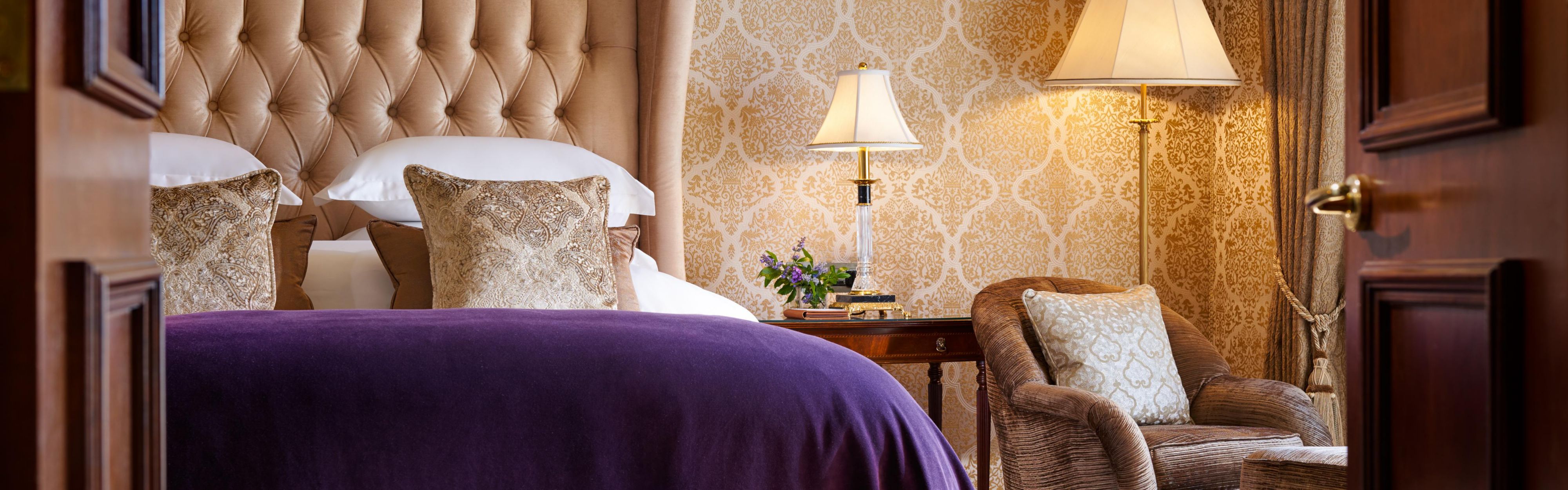 james joyce suite with king-sized bed, cisy armchair, and ottomen