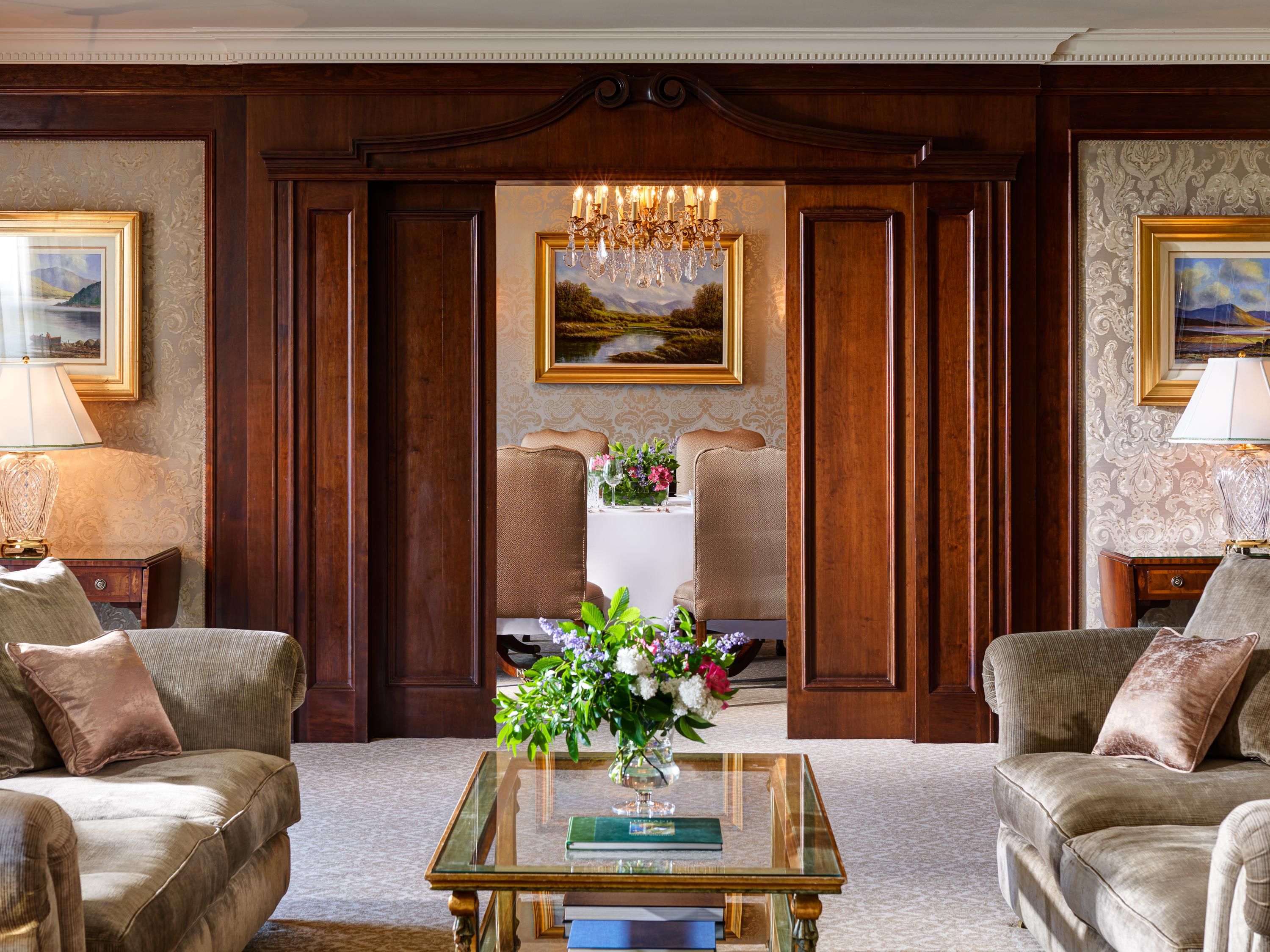 large living area in luxry suite with sofas, a coffee table and artwork