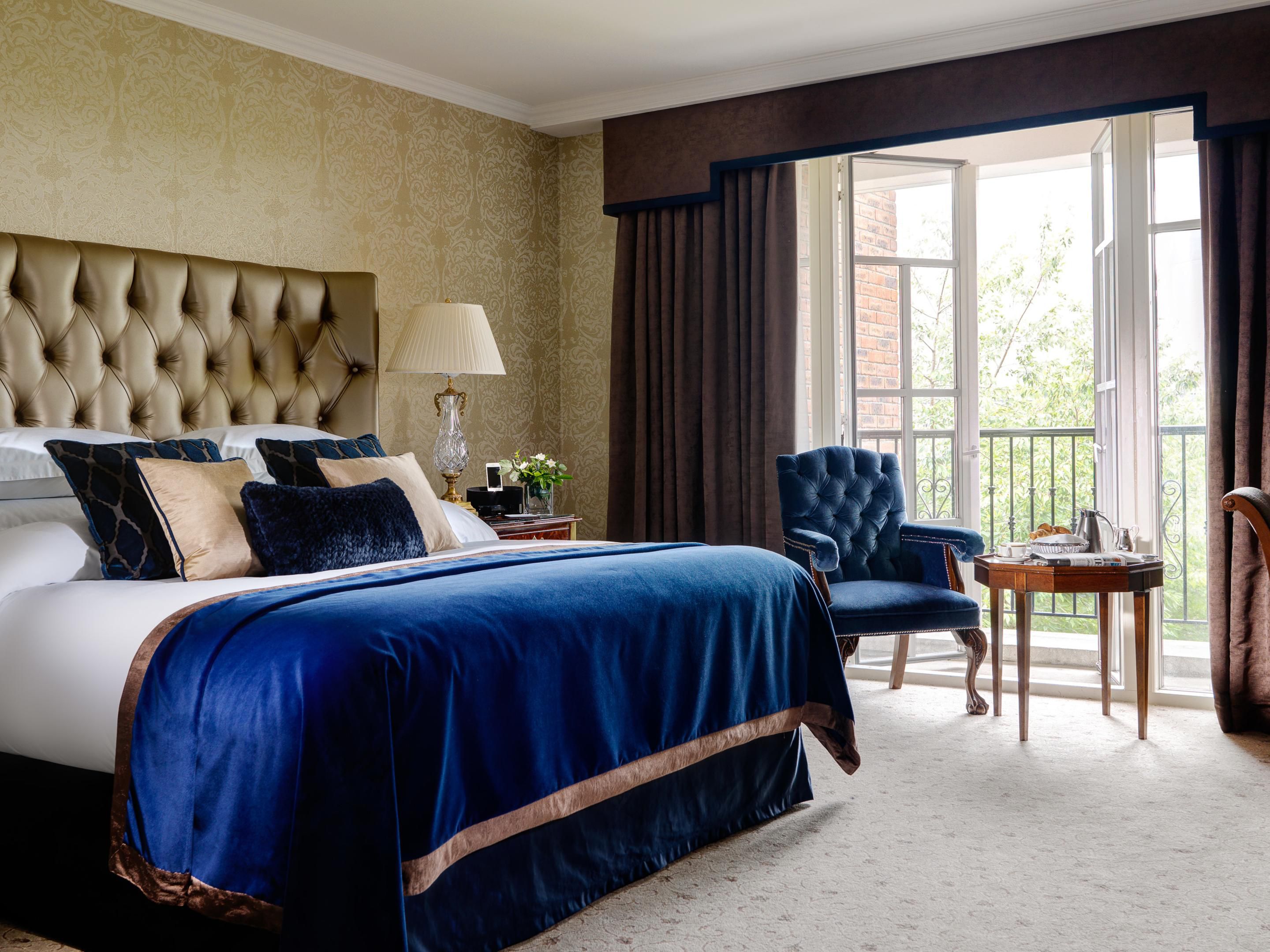 wb yeats suite featuring a king sized bed with a electirc blue comforter and balcony