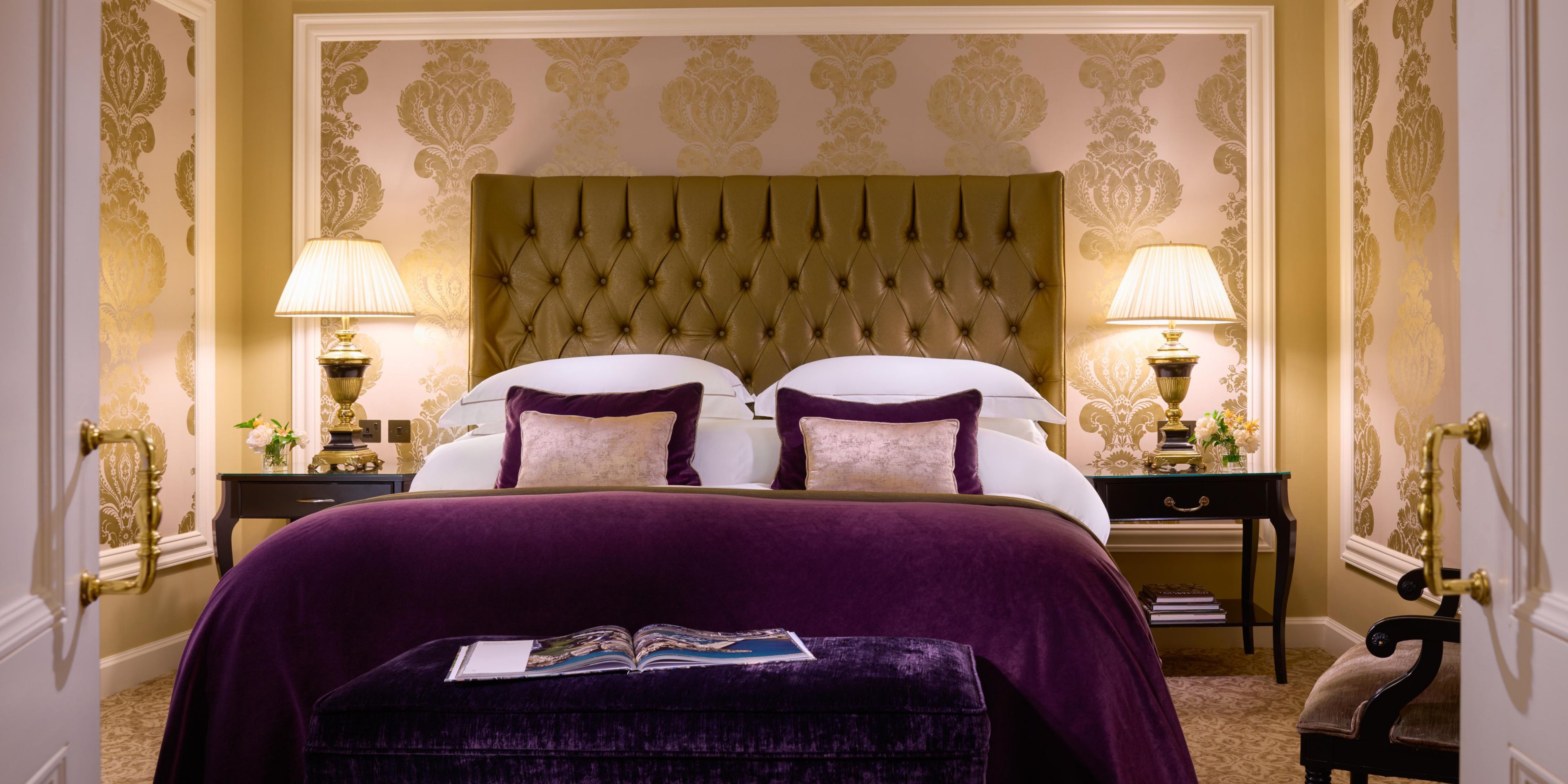 One Bedroom Suite featuring a bed, ottomen and purple comforter