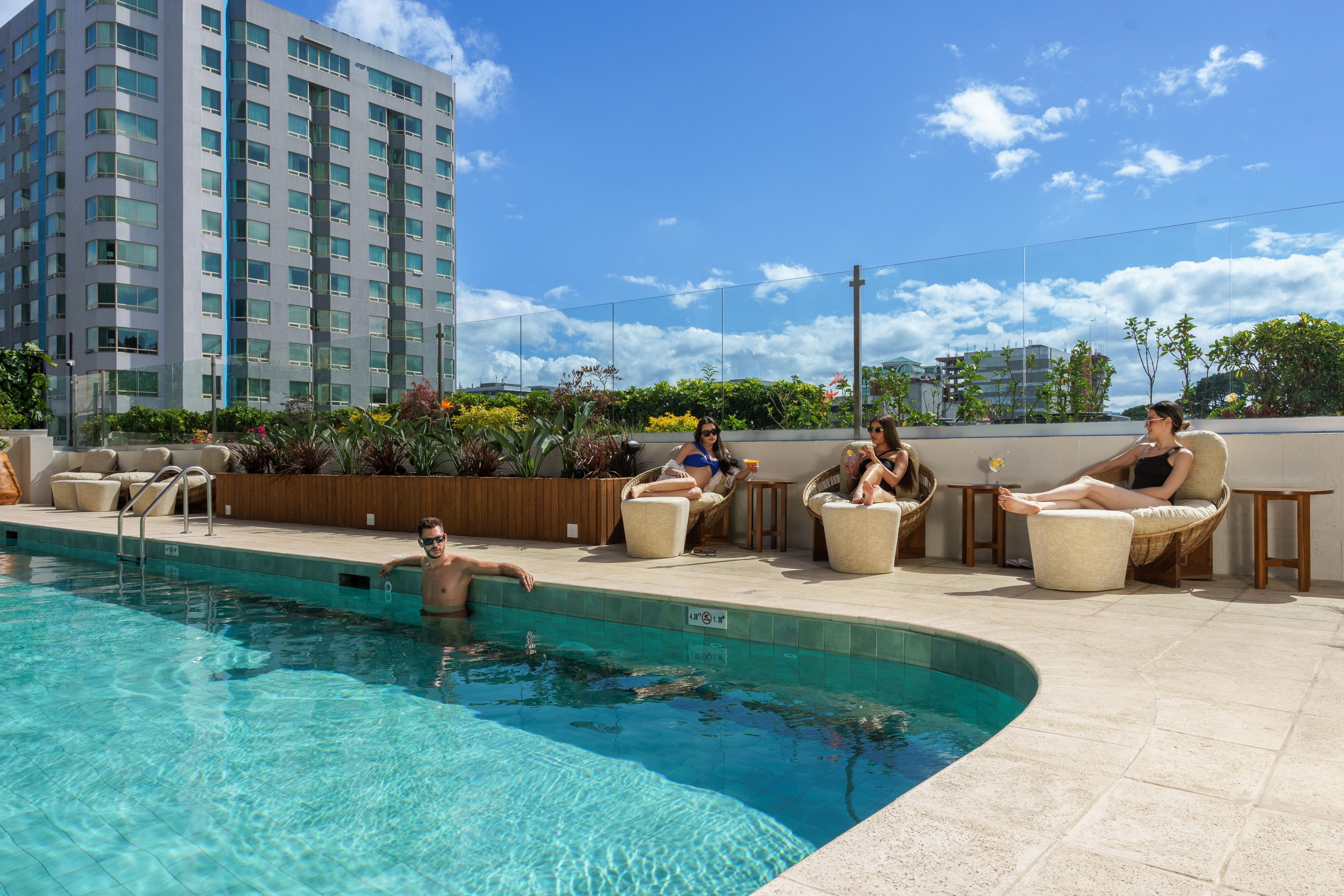 A group of friends lounging by the pool at InterContinental The Real Guatemala