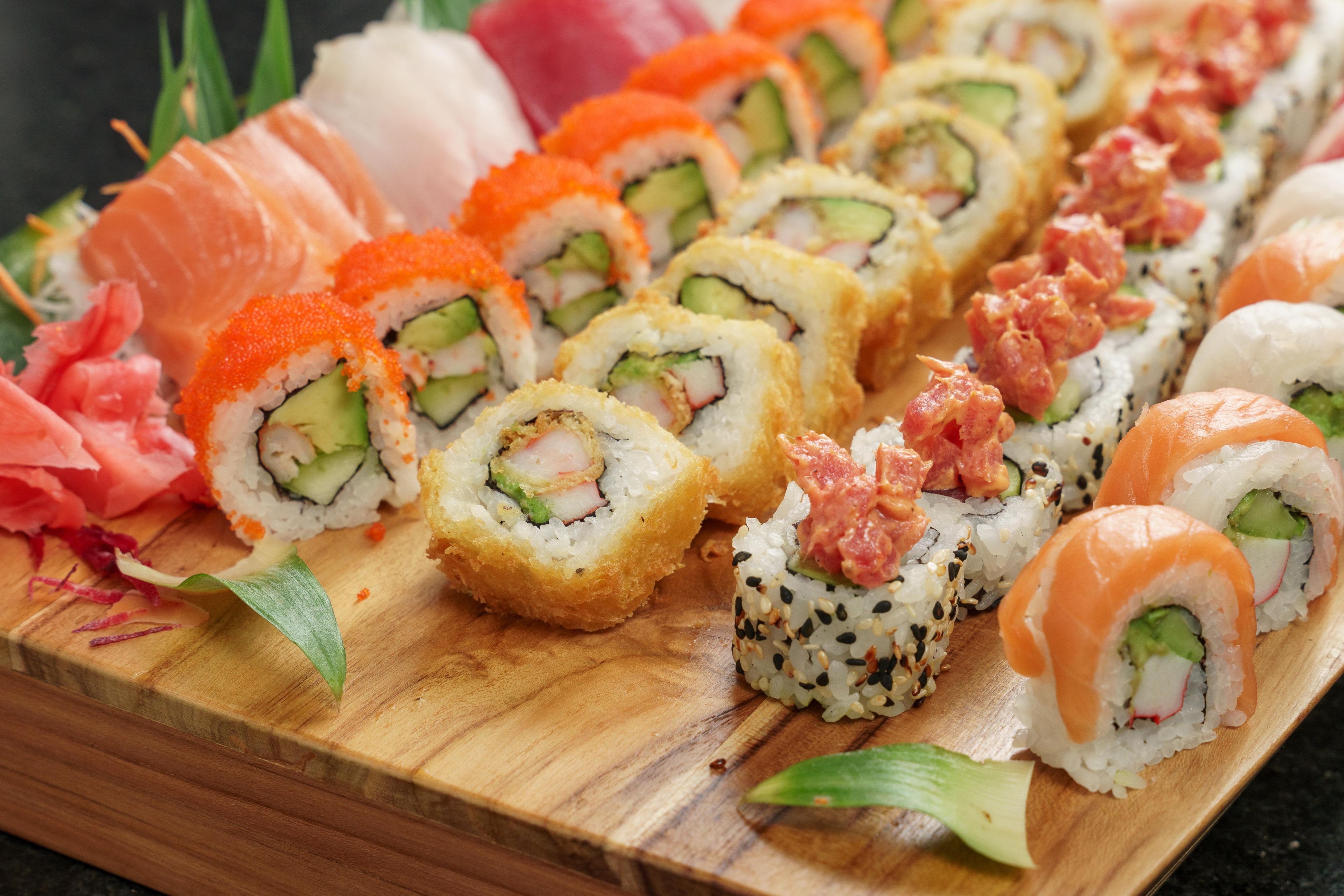 Wooden board of various sushi rolls 