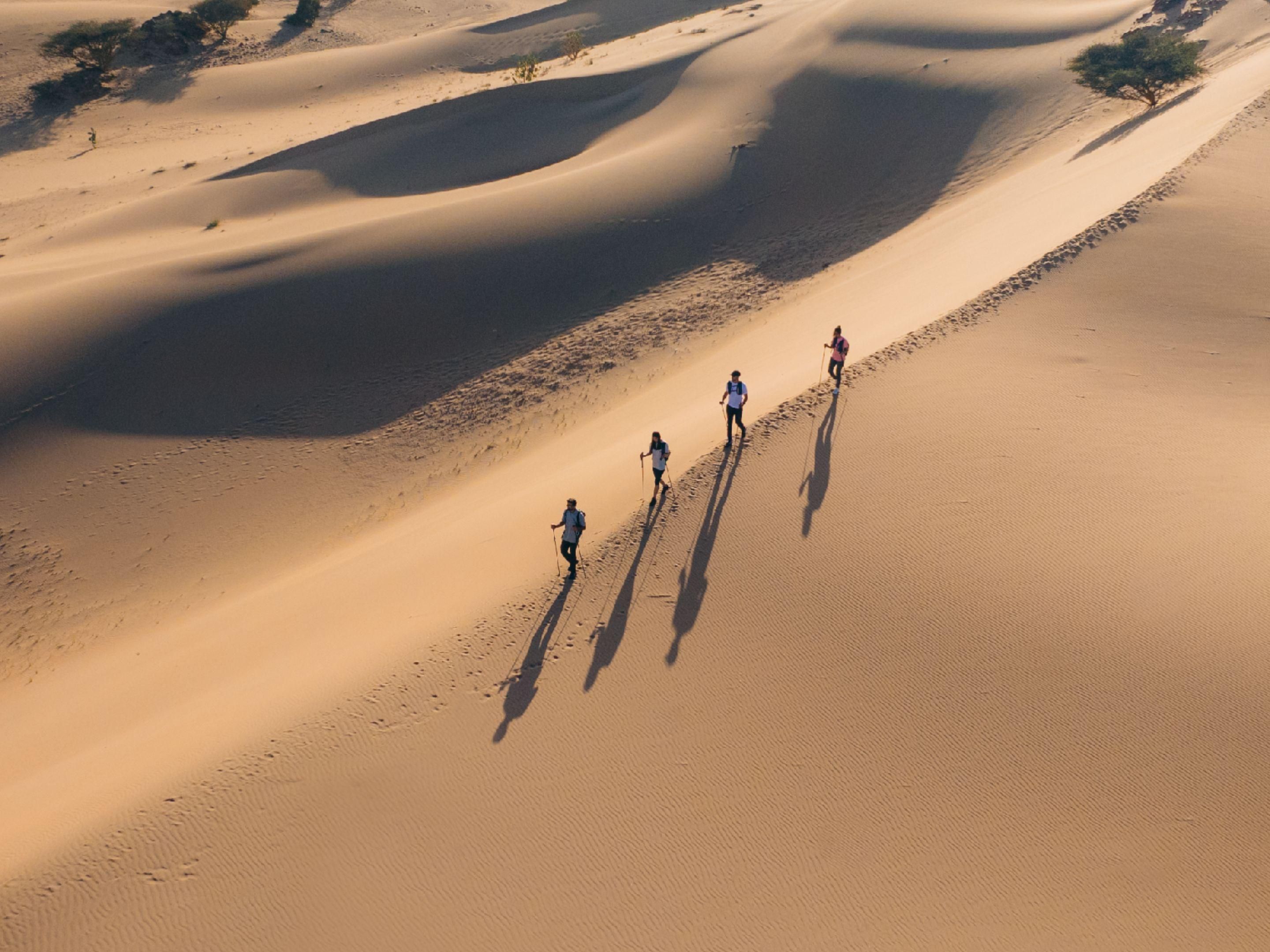 Man standing by his car in parking lot.
