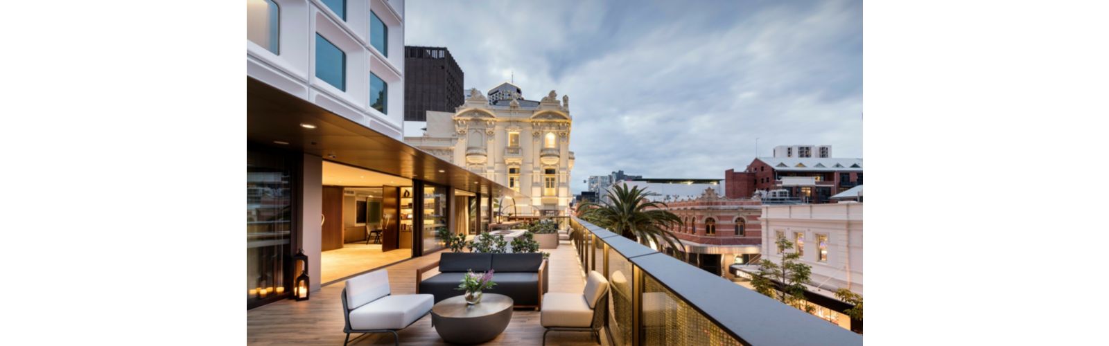 Large balcony with modern furniture overlooking city