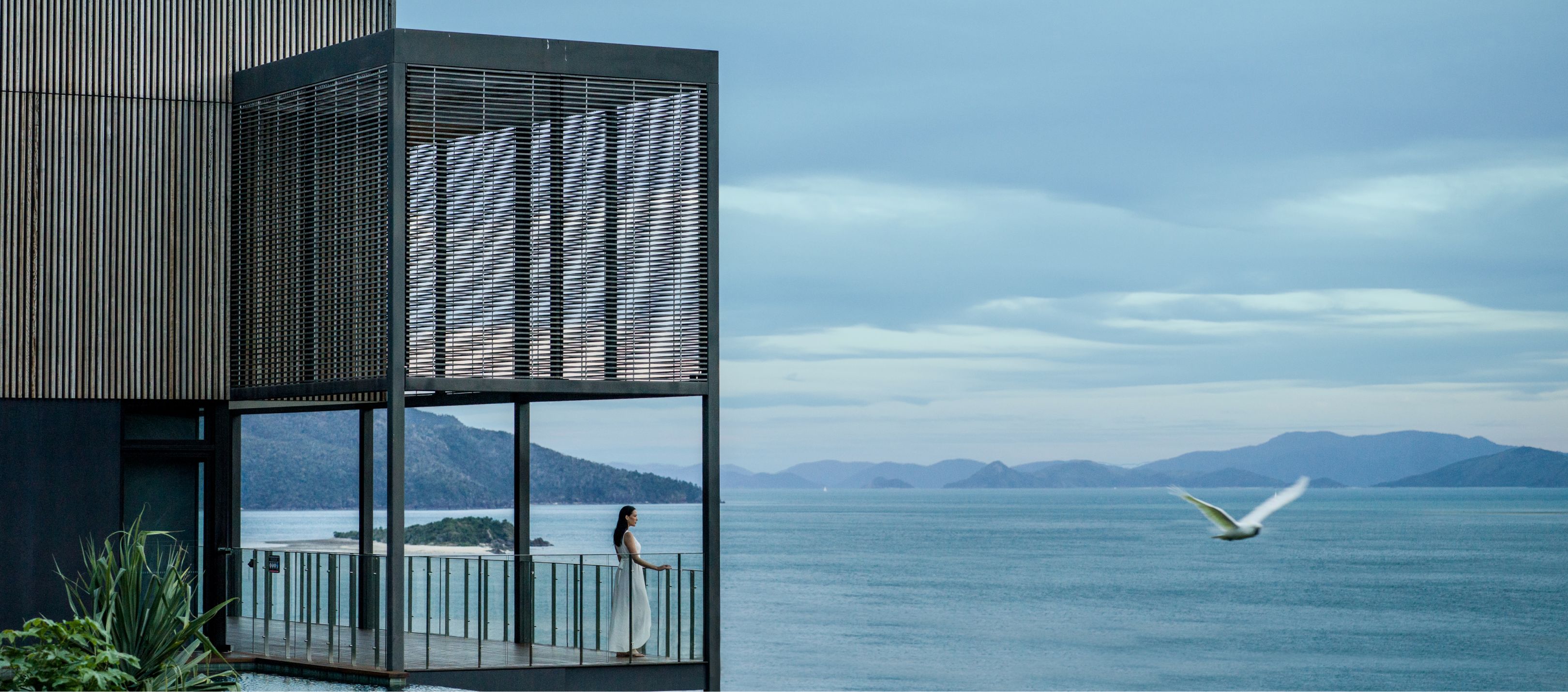 Woman looking over the lake from balcony