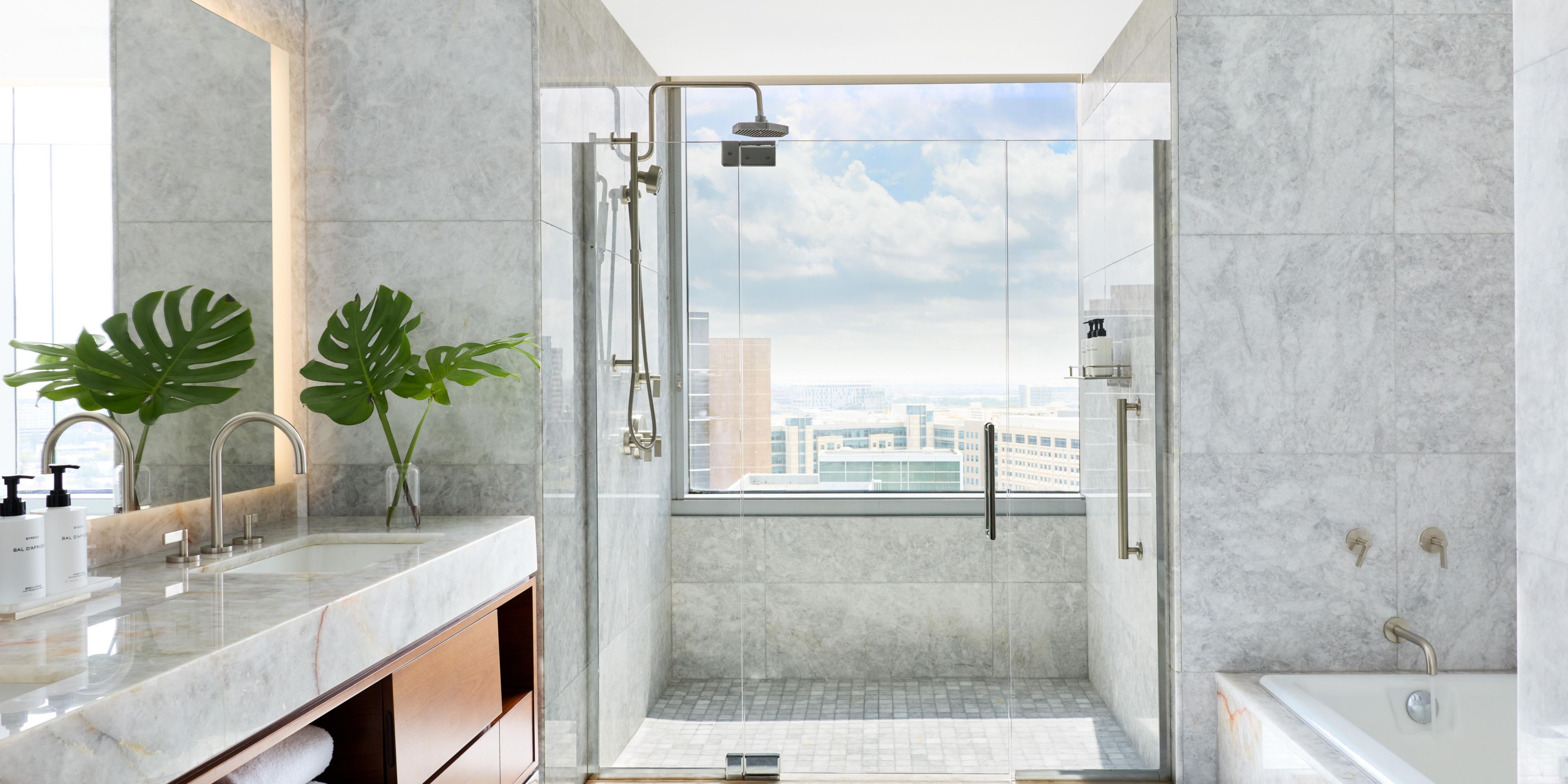 Walk-in shower with rain head and sleek tile surround. 
