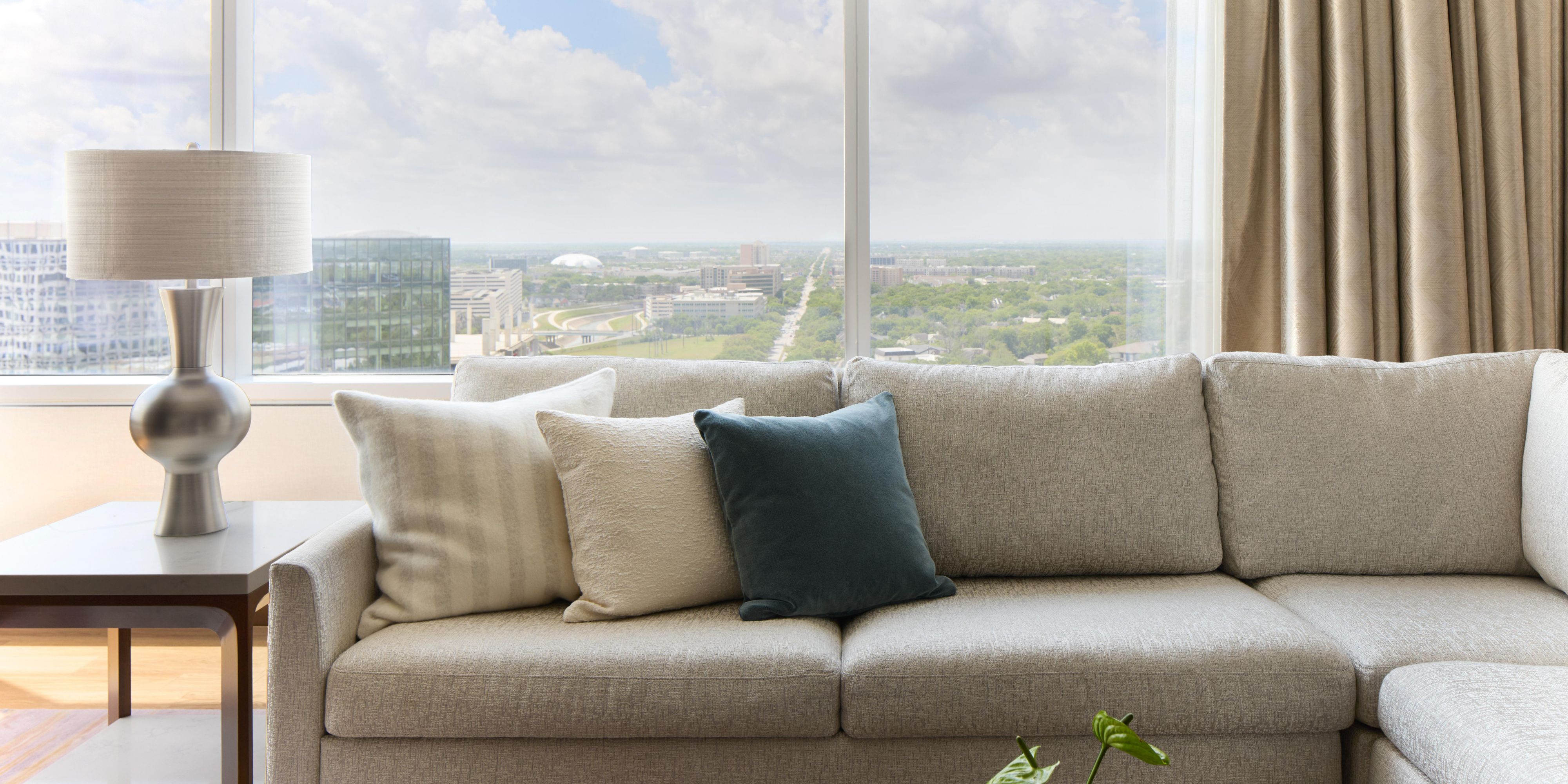 Living room with sofa and city skyline view.