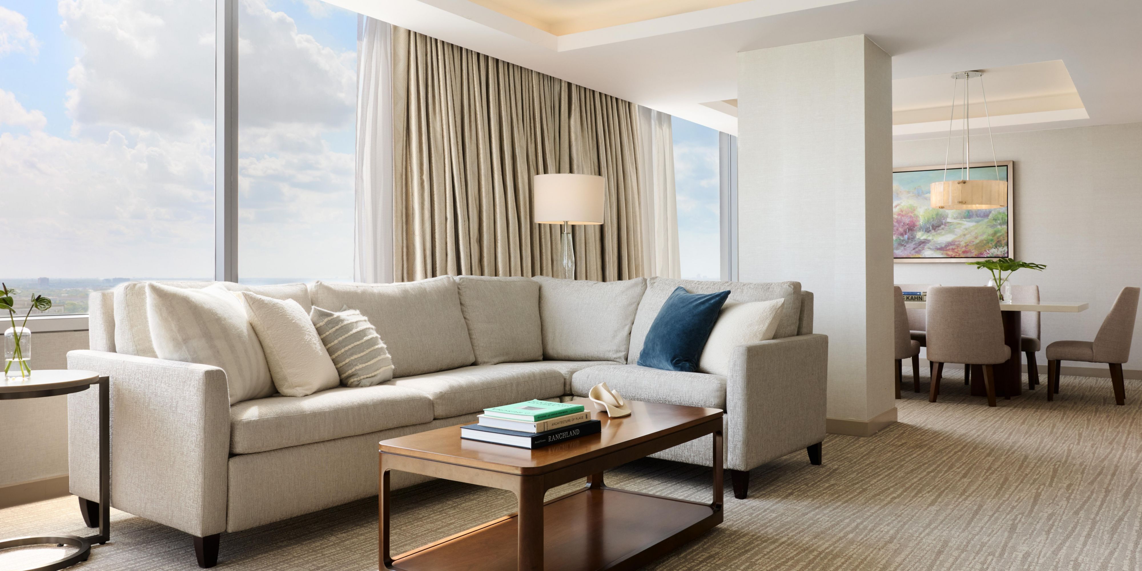Living room with sectional sofa and large windows.