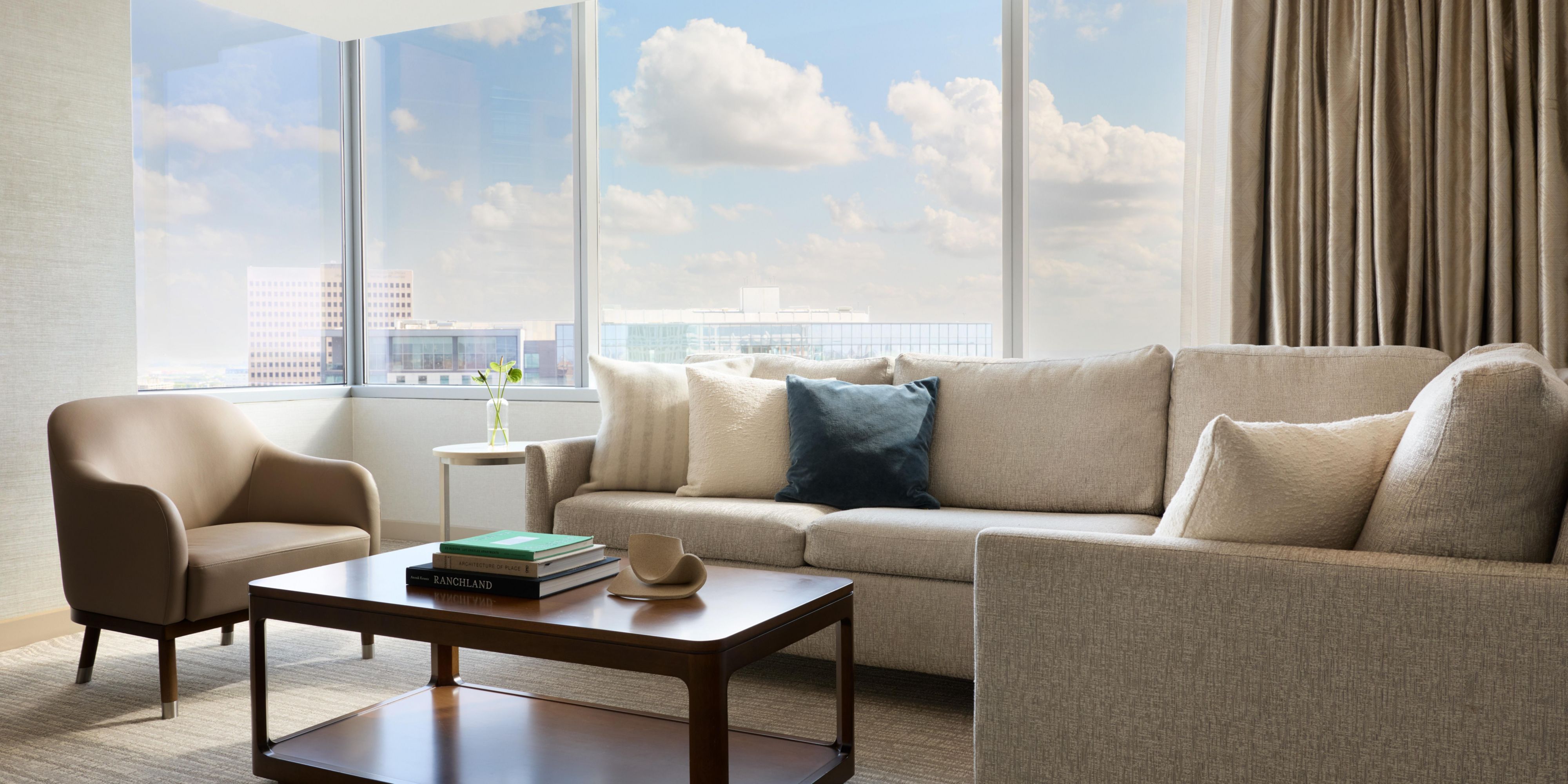 Living room with sofa and floor-to-ceiling windows.