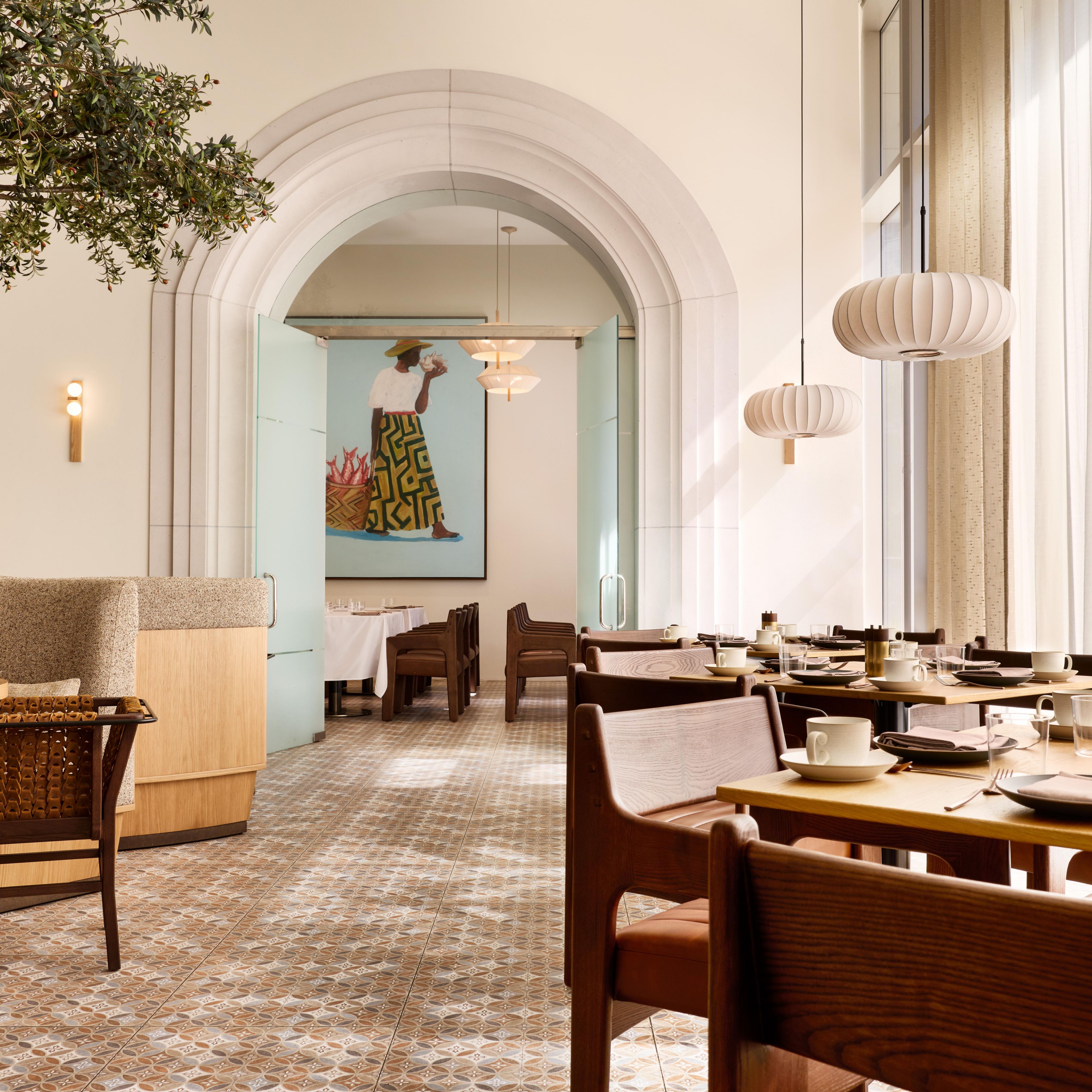 Restaurant dining room with wood tables and arched doorway