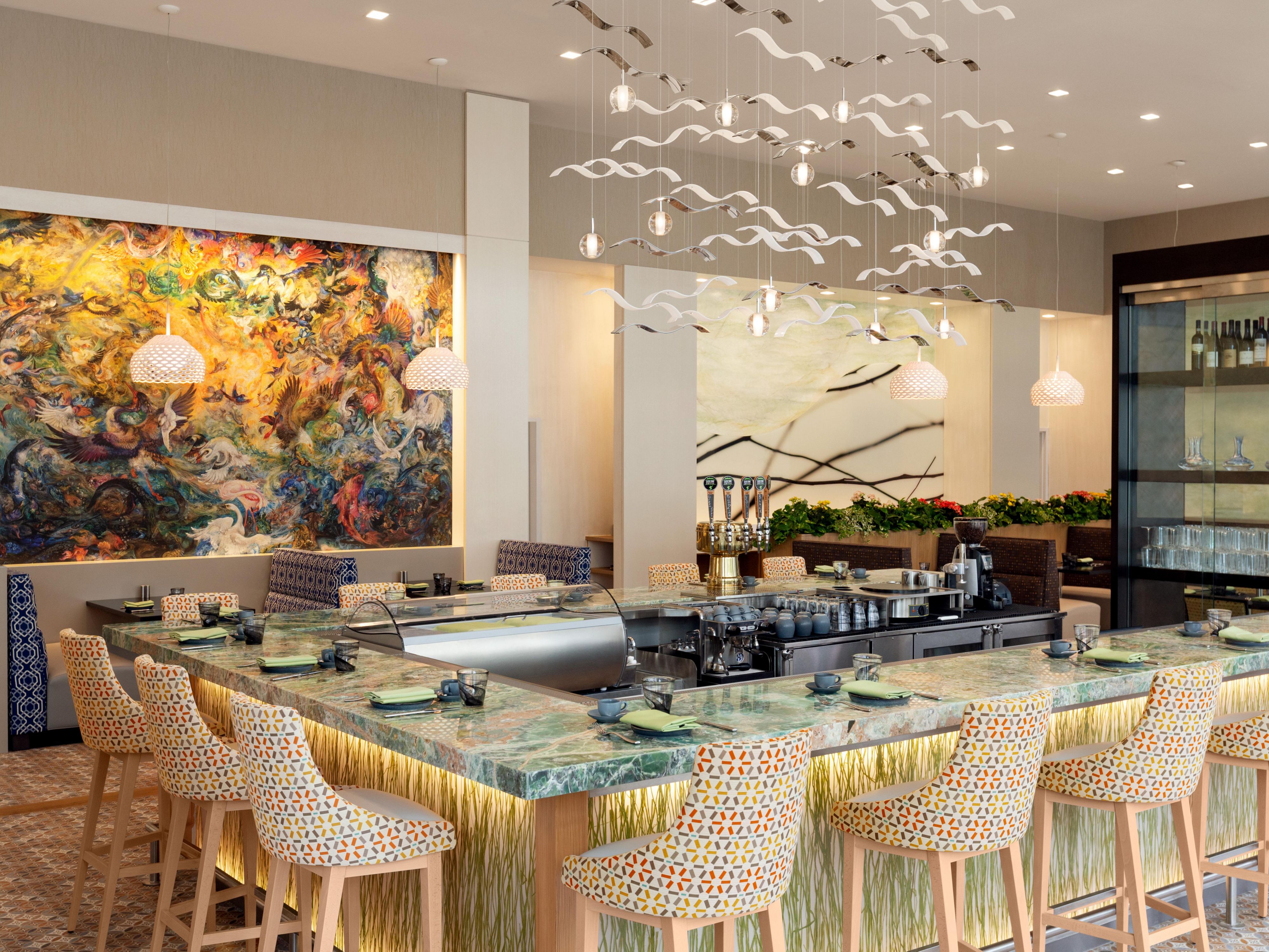 Custom artwork surrounds you at Safina Restaurant in Houston.