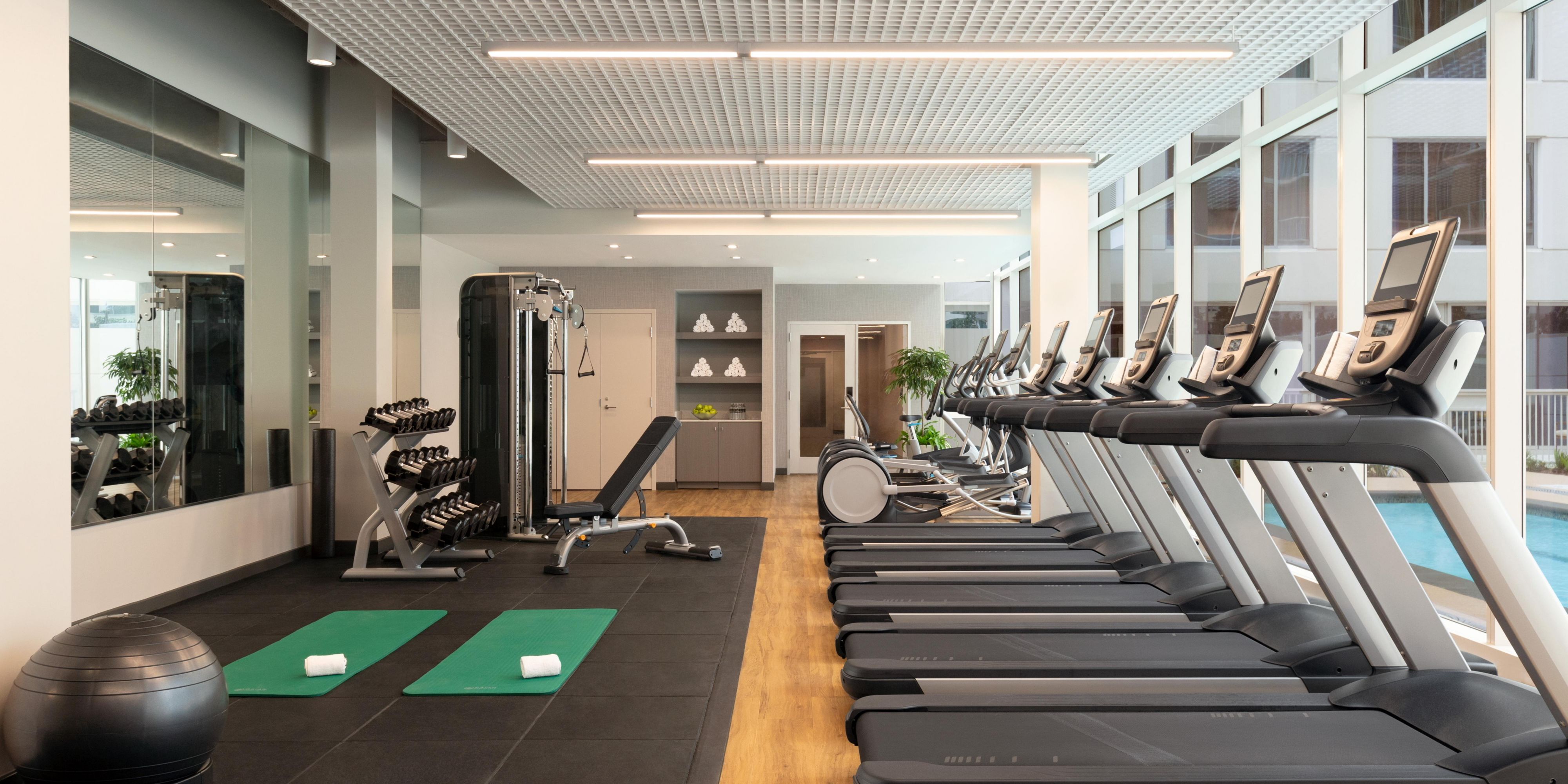 Enjoy a workout with state-of-the-art equipment & a pool view.