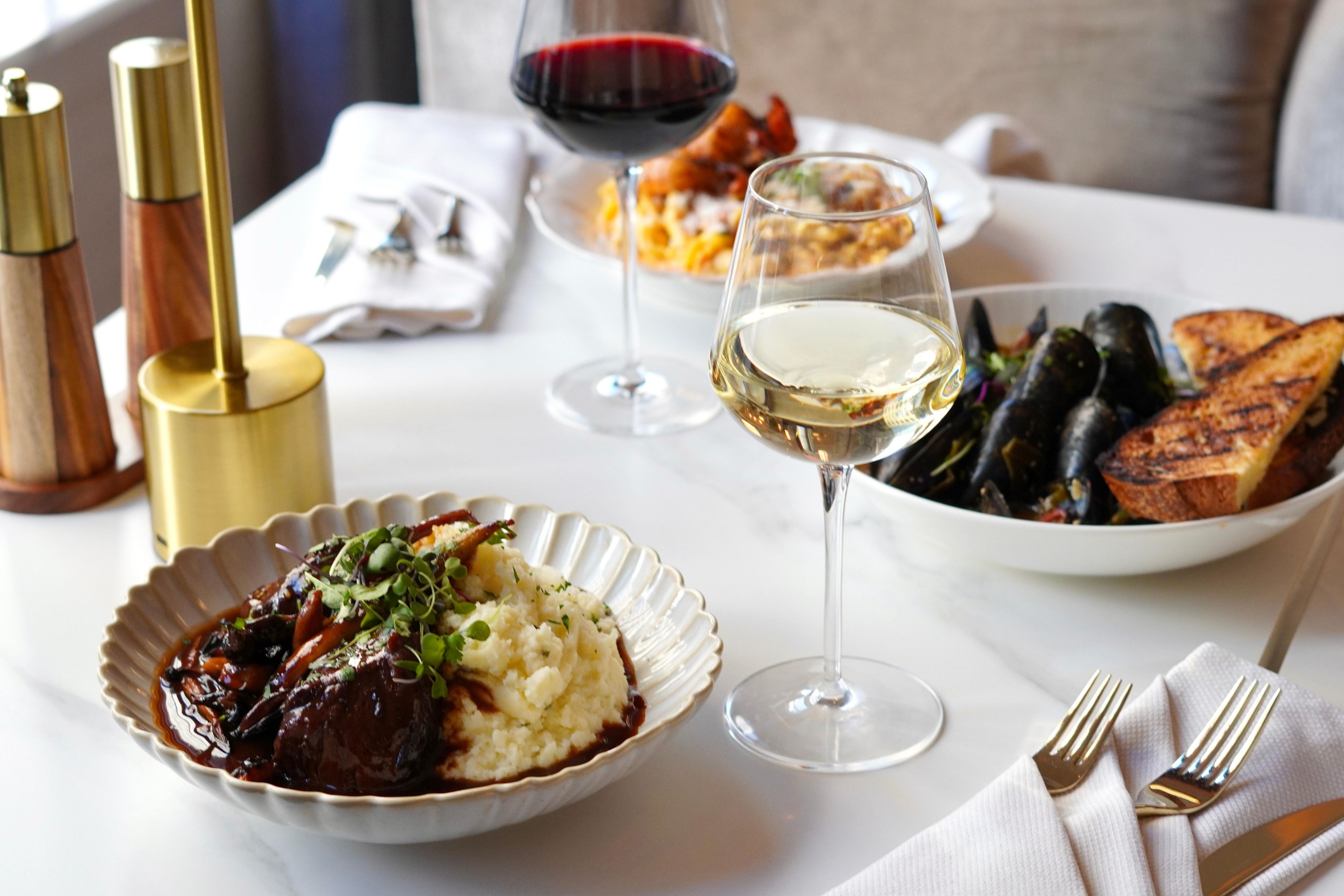 Signature Serliana favorites: steamed mussels and rack of lamb.