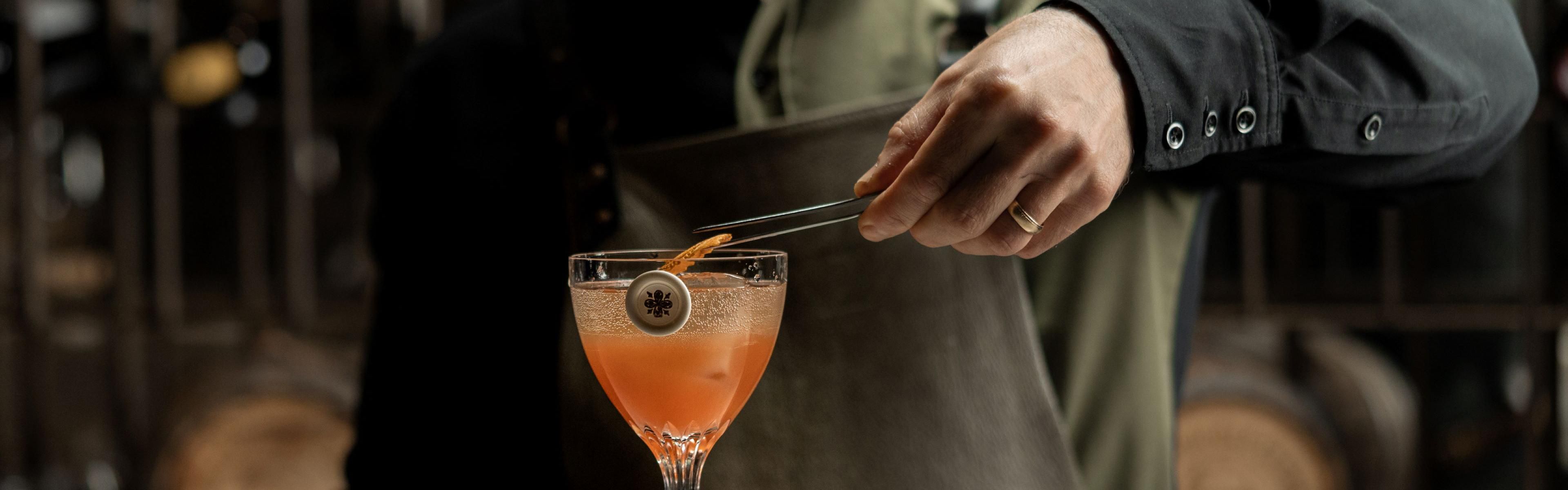 bartender adding finishing touches to the cocktail