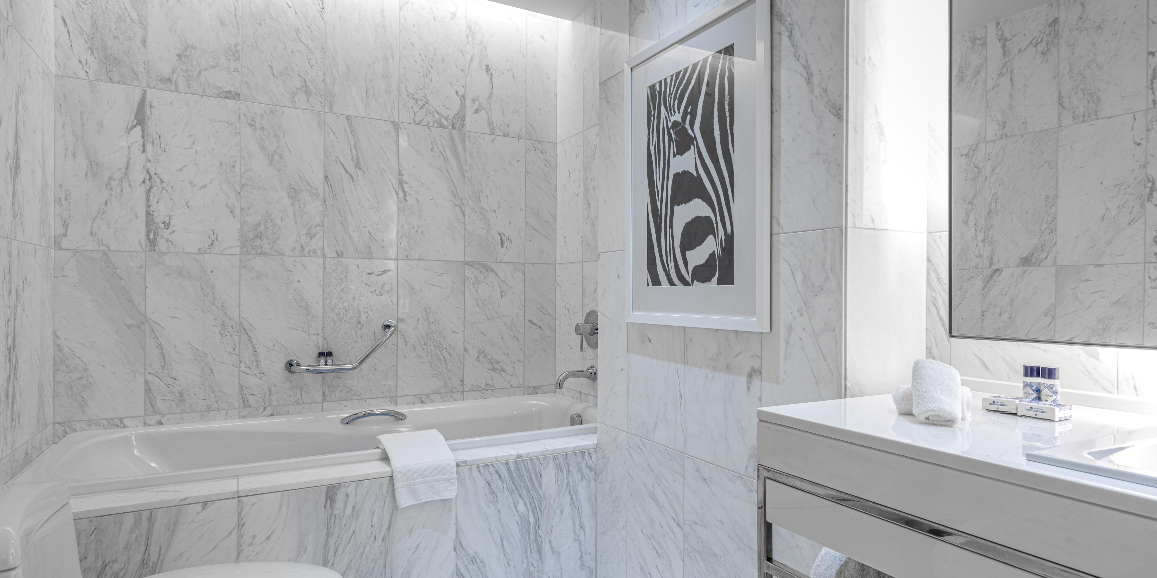 Enjoy a bathtub and oversized shower with Agraria luxury amenities