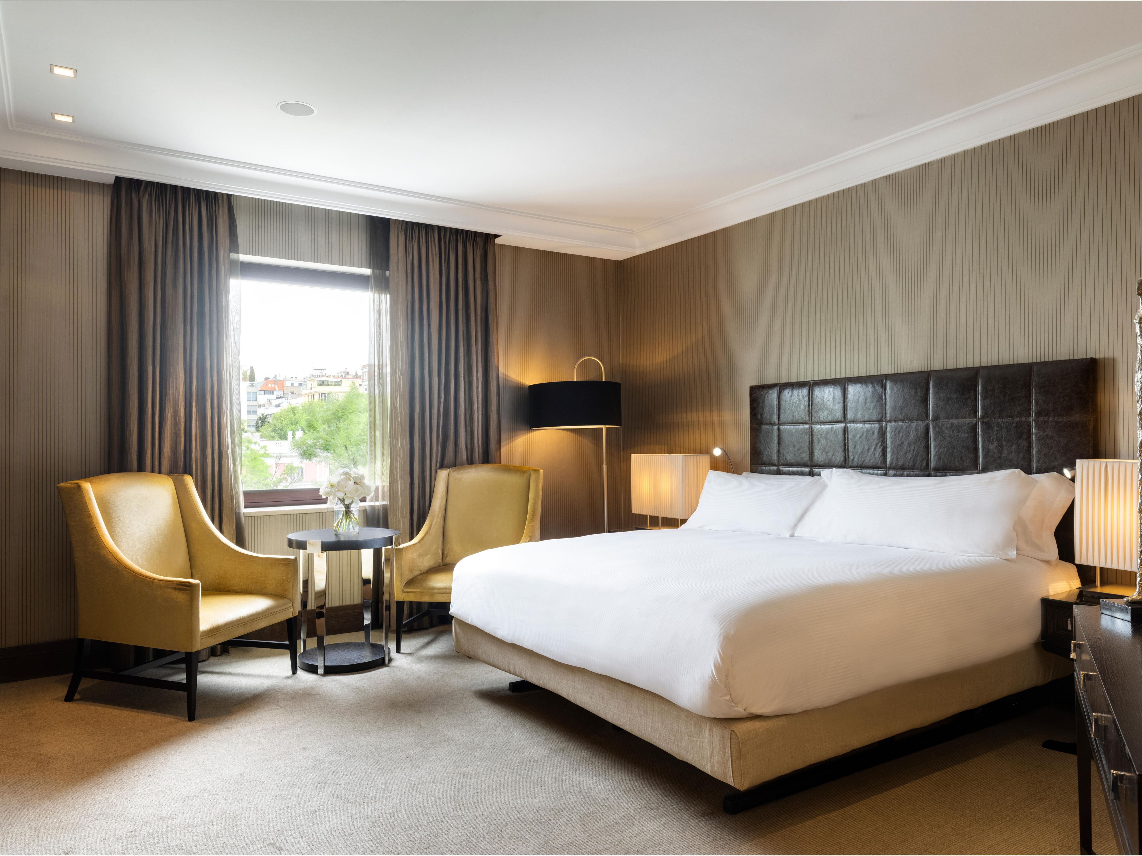 Spacious contemporary bedroom of Presidential Suite.
