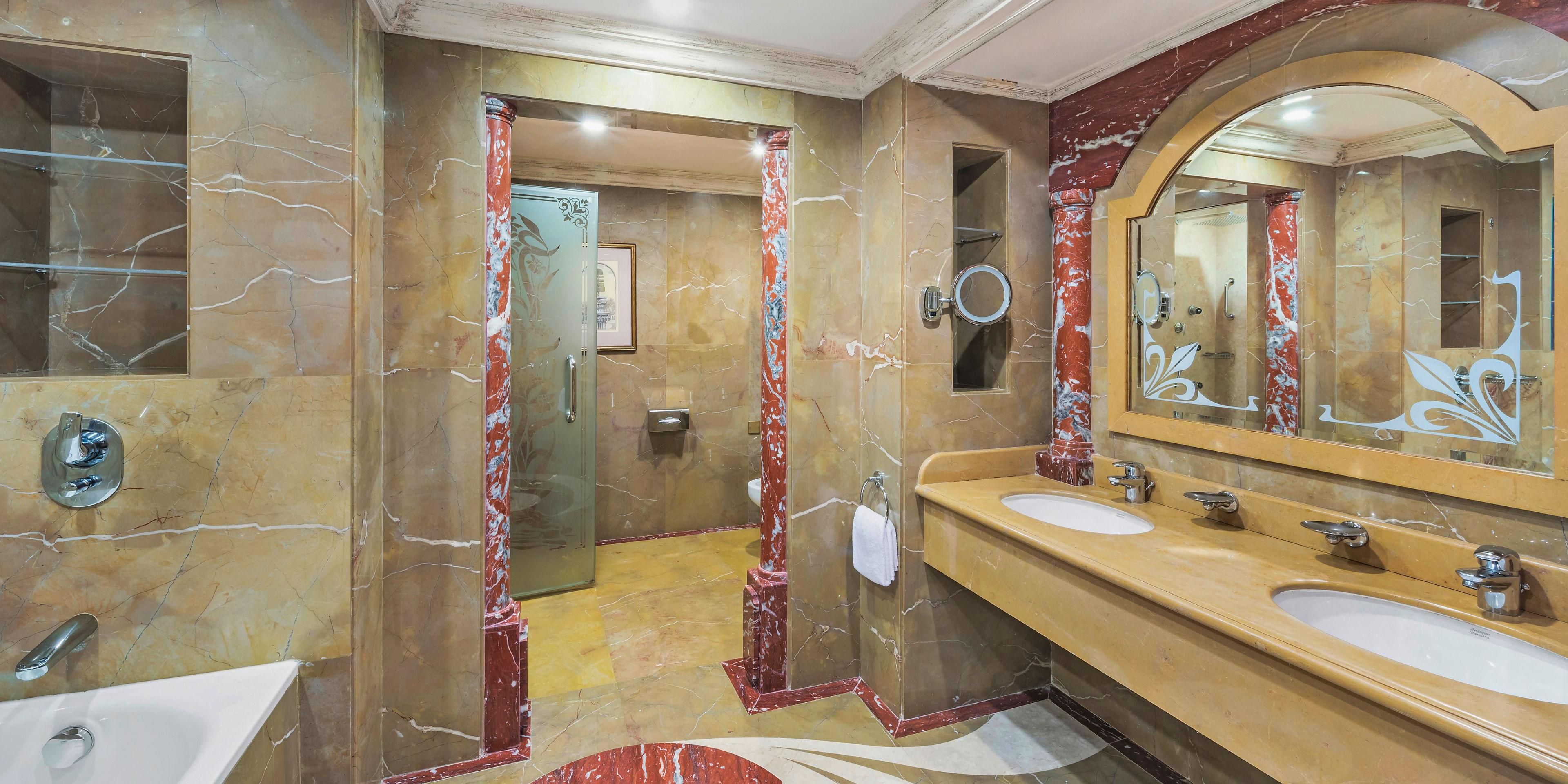 Soothe your senses in the Royal Suite's opulent marble bathroom