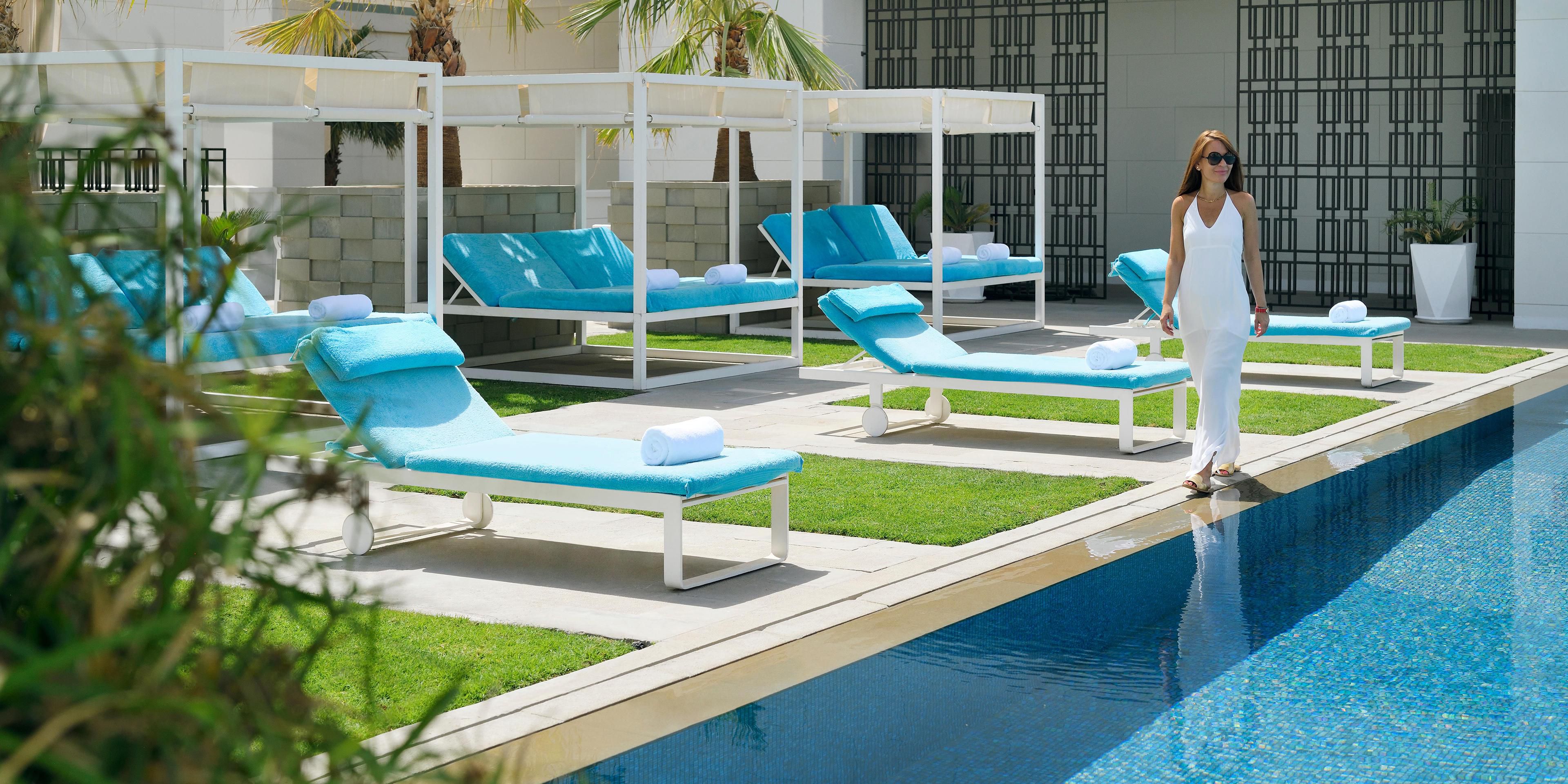 Relax on our comfortable sunbeds by the poolside