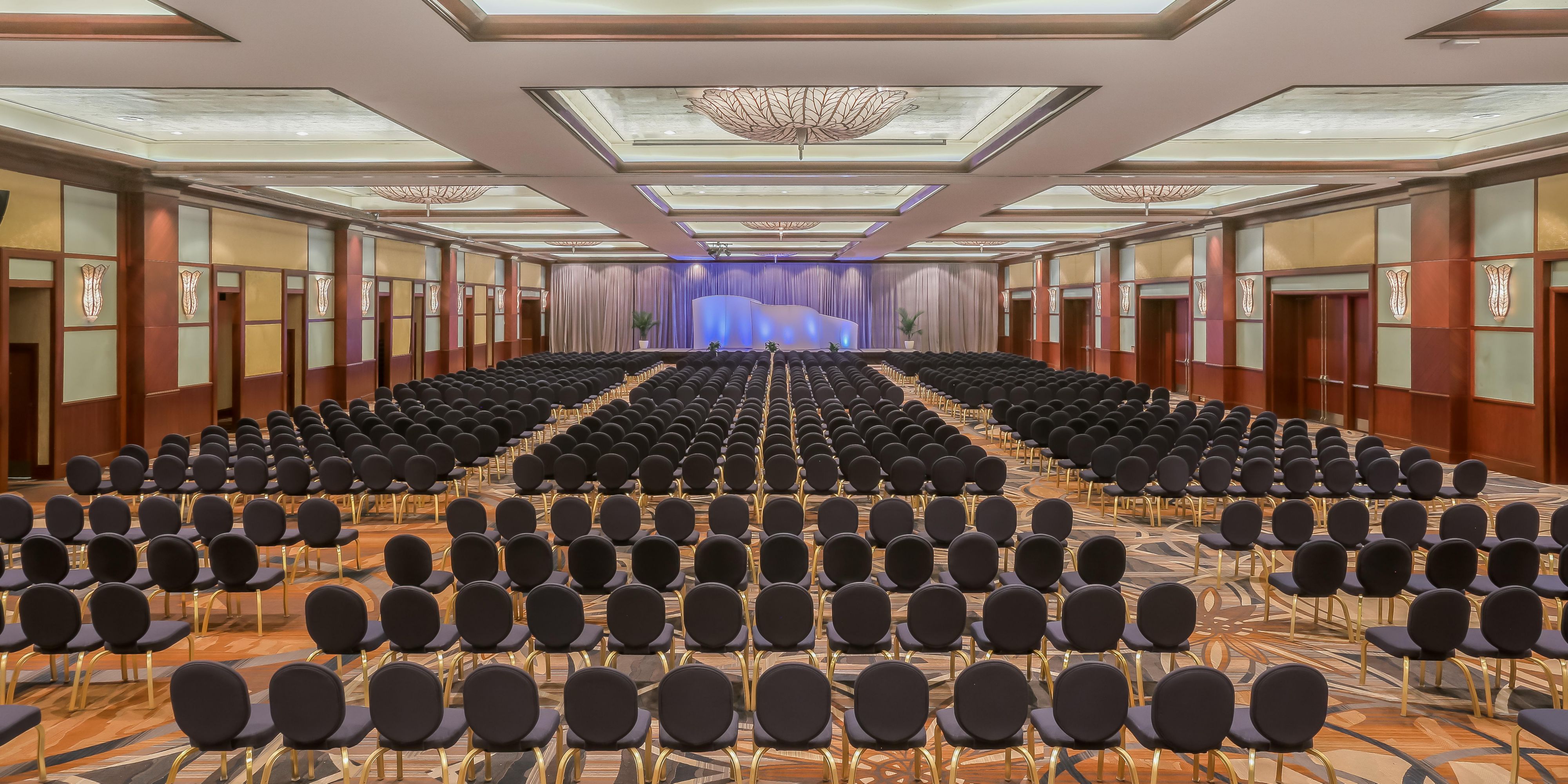 Versatile Grand Ballroom with conference chairs.