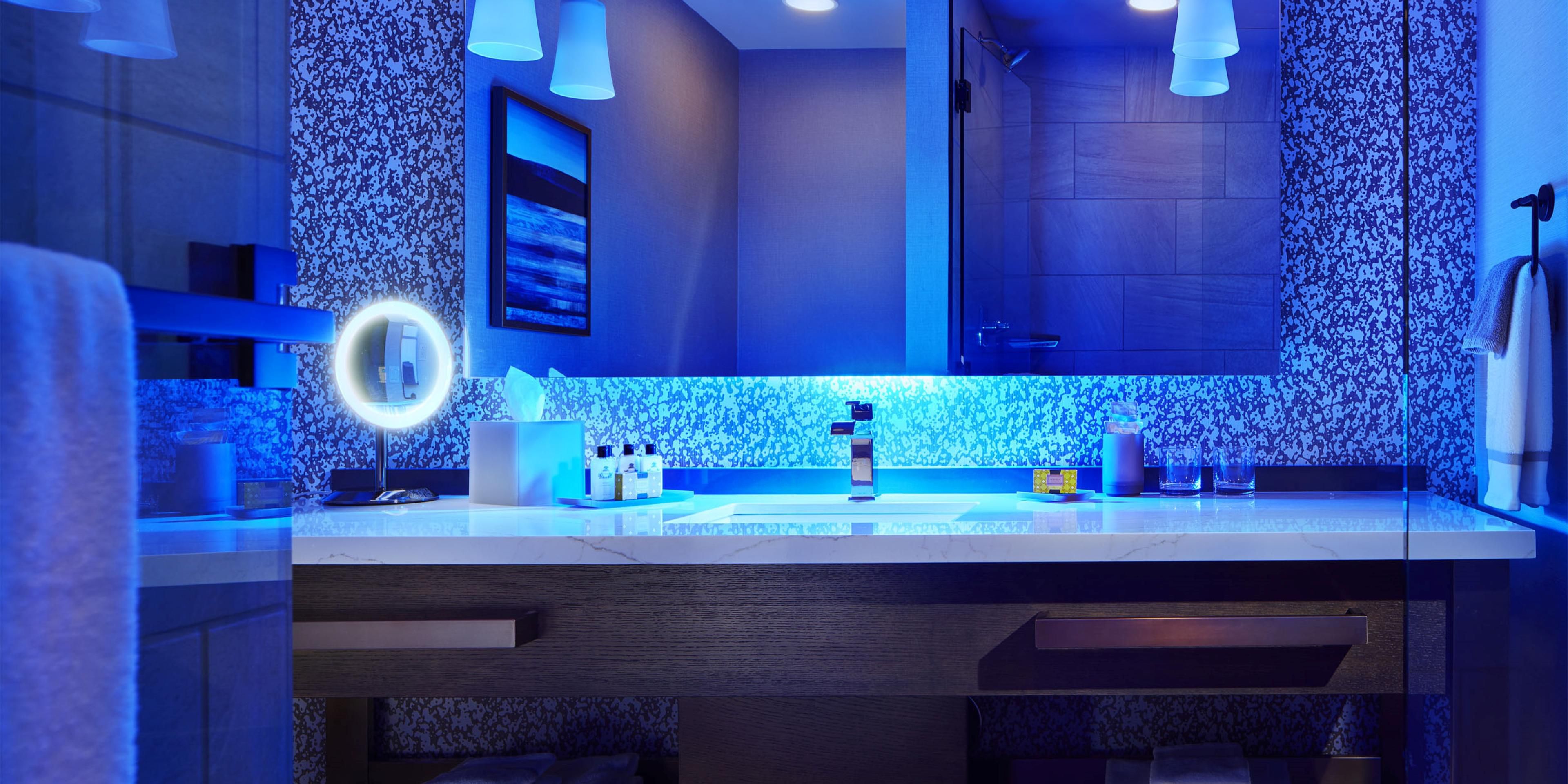 Guest bathrooms are spacious and feature ambient lighting
