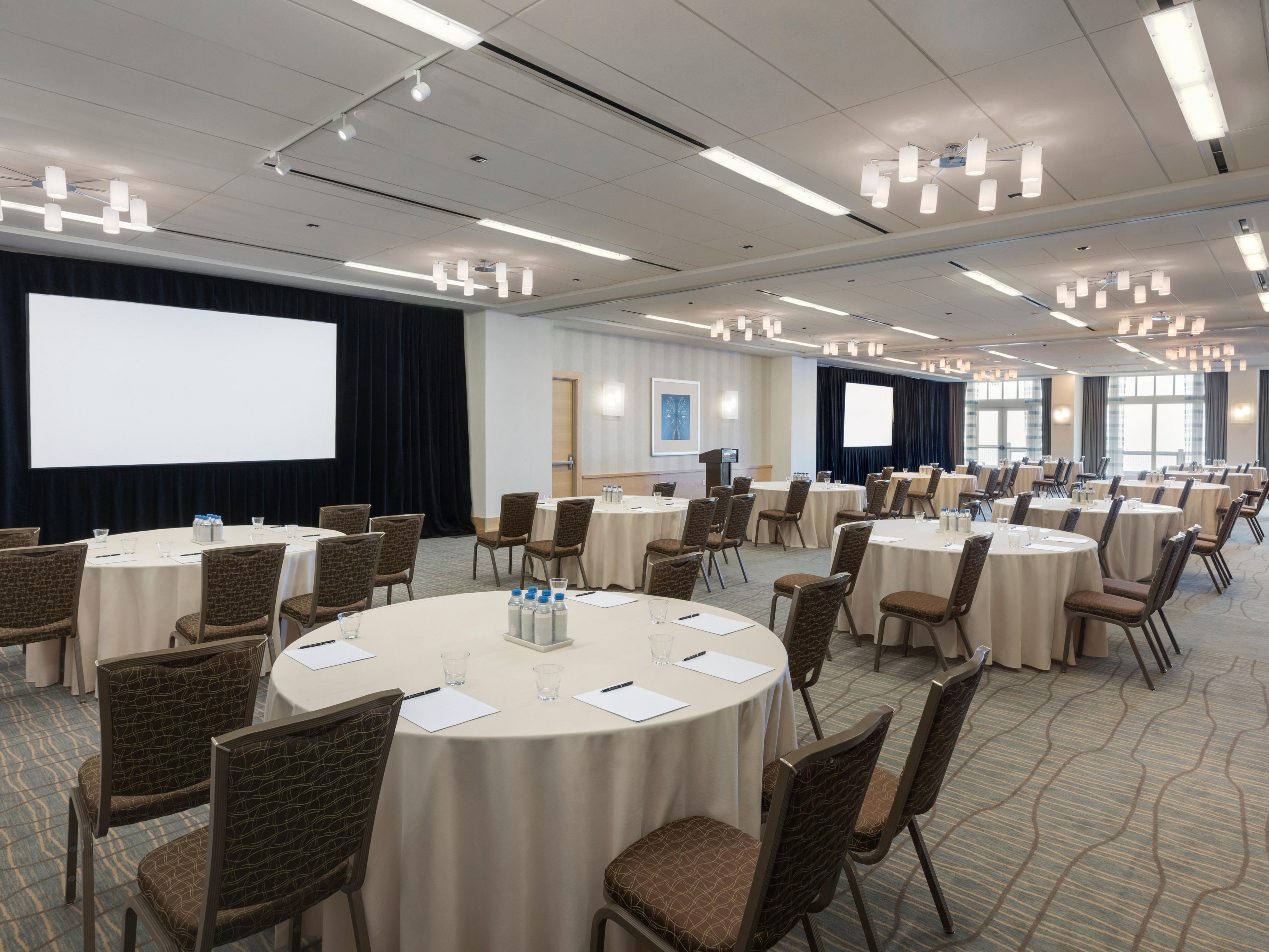 Ocean Terrace Ballroom set up with round tables for a presentation.
